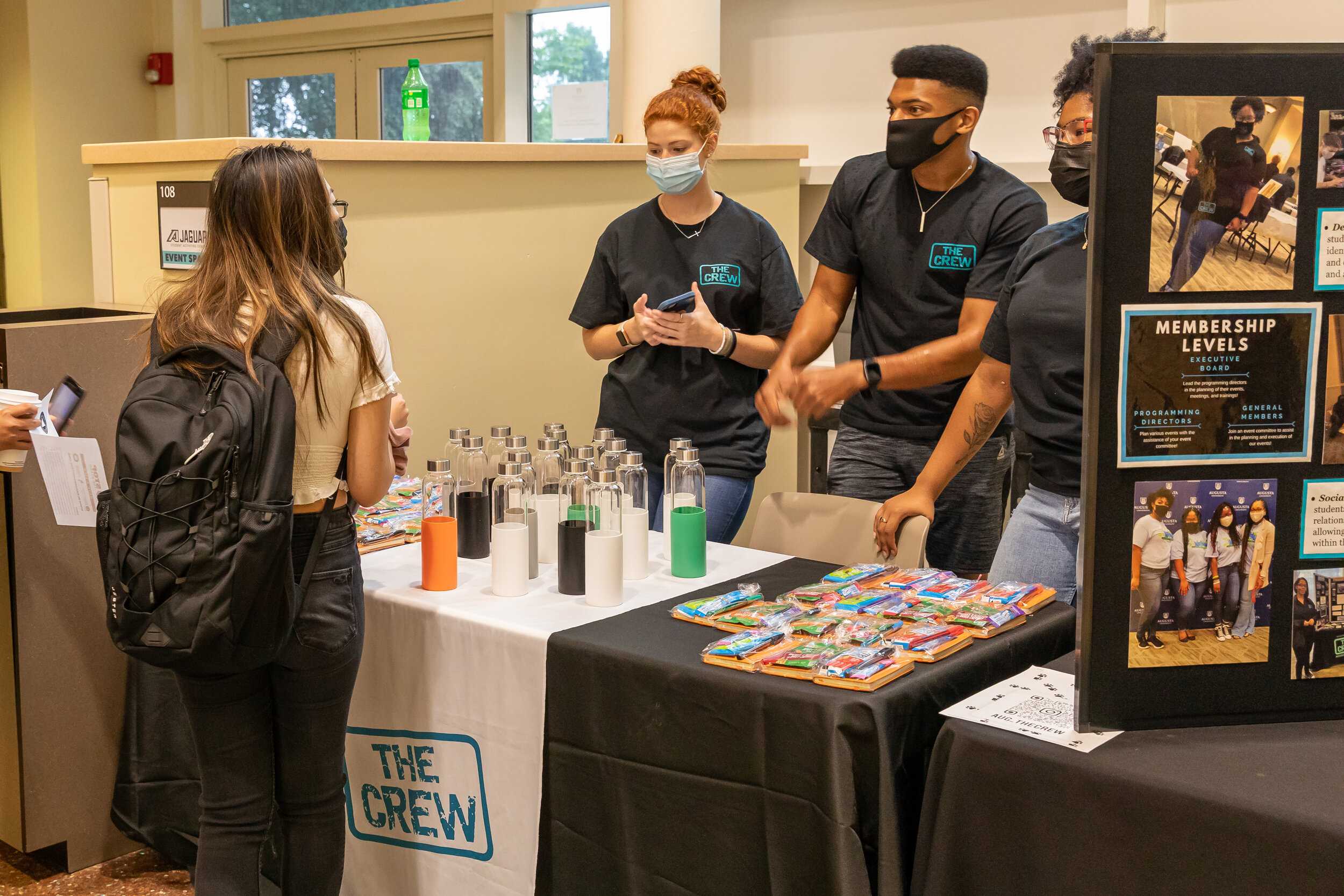  Crew members give out water bottles, swag and information  to Augusta University students. (photos by Chris Woods) 
