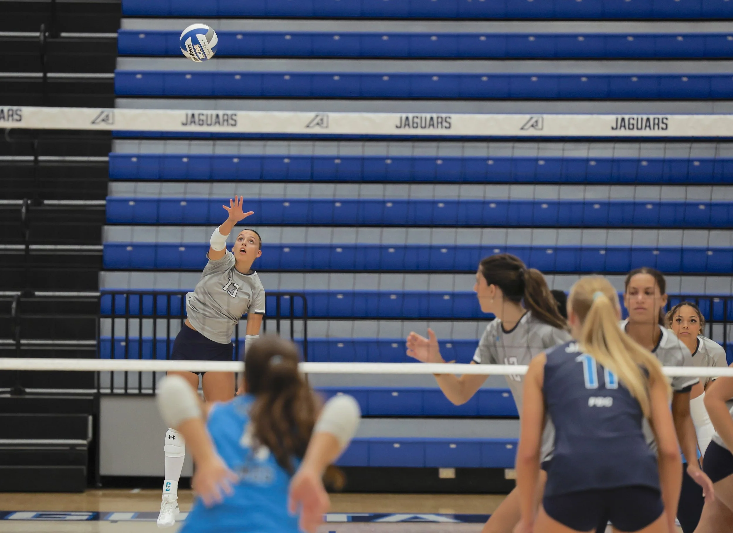  Sydney Harrington (13) serves during the Blue-Grey match at Christenberry Fieldhouse, as the Jaguars prepare for their season-opening weekend in Florida. (photo by Lydia Williams/the Bell Ringer) 