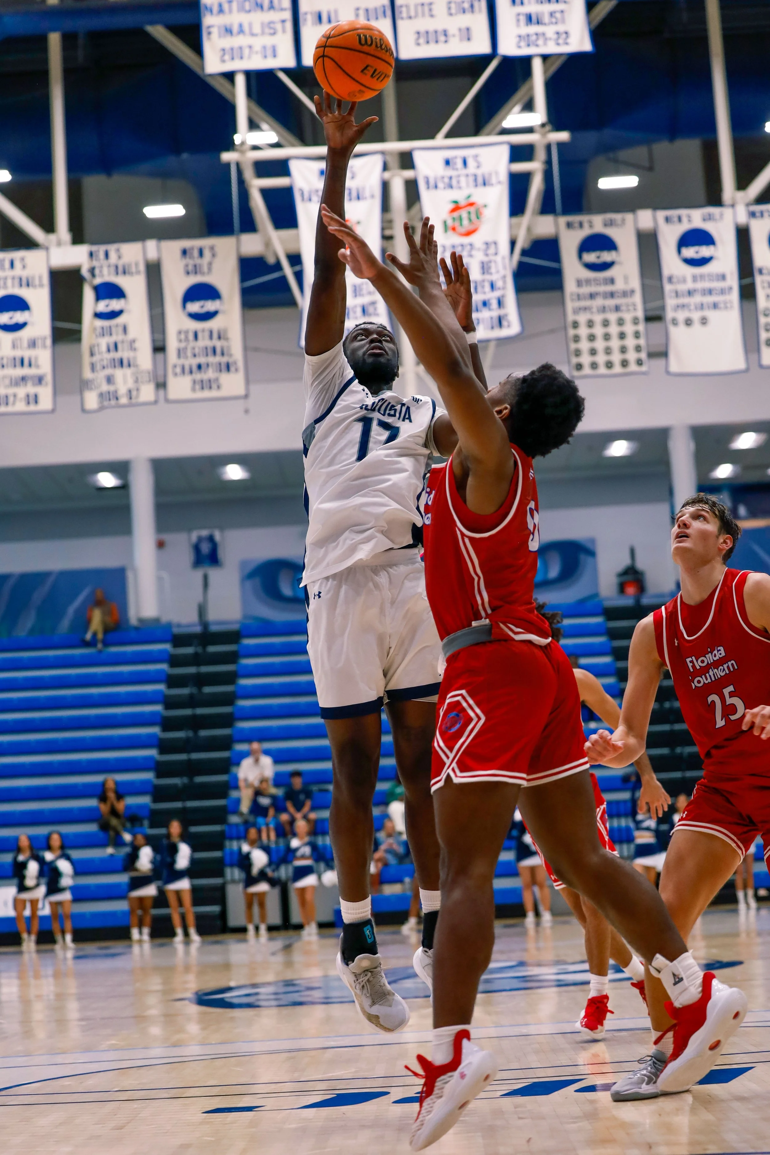  Max Amadasun (17) gets two of his 17 points on a half hook over Florida Southern’s Amare Miller. At the top of the page, AU’s Luis Nonfon s(24) crambles for a loose ball on the floor against the Mocs’ Hugo Mattioli (77) in the home opener for the Jaguars. (photos by Lydia Williams/the Bell Ringer) 