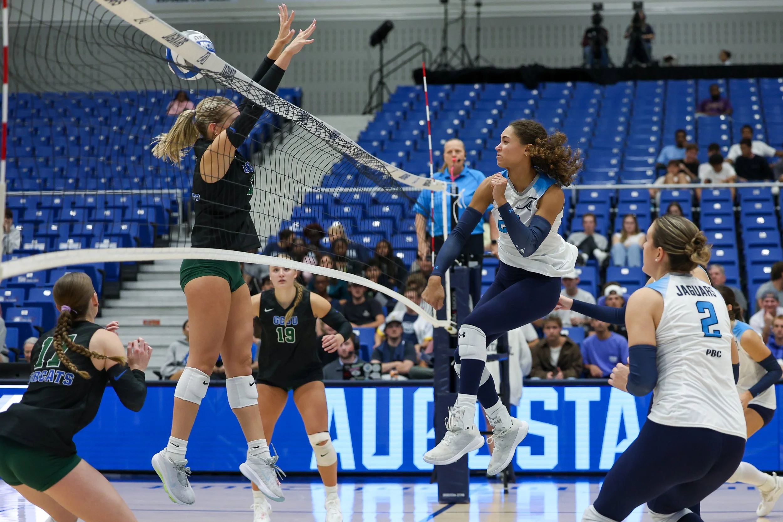  Augusta’s Layne Witherspoon (20) gets one of her seven kills as the league-leading Jaguars down the Bobcats in three sets at Christenberry Fieldhouse in a Peach Belt Conference match. (photo by Lydia Williams/the Bell Ringer) 