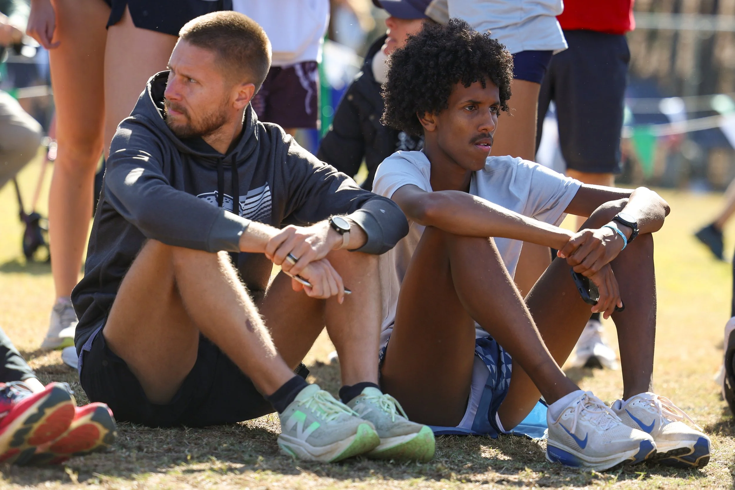 AU’s Nasrudin Mohamed (R) finished in 25:15.9, good for sixth place. Here he sits next to AU coach Jacob Burgamy during the awards ceremony. At the top of the page, the Jaguars’ Andrew Helfers (26) races home in third place. (photos by Lydia Williams/the Bell Ringer)  