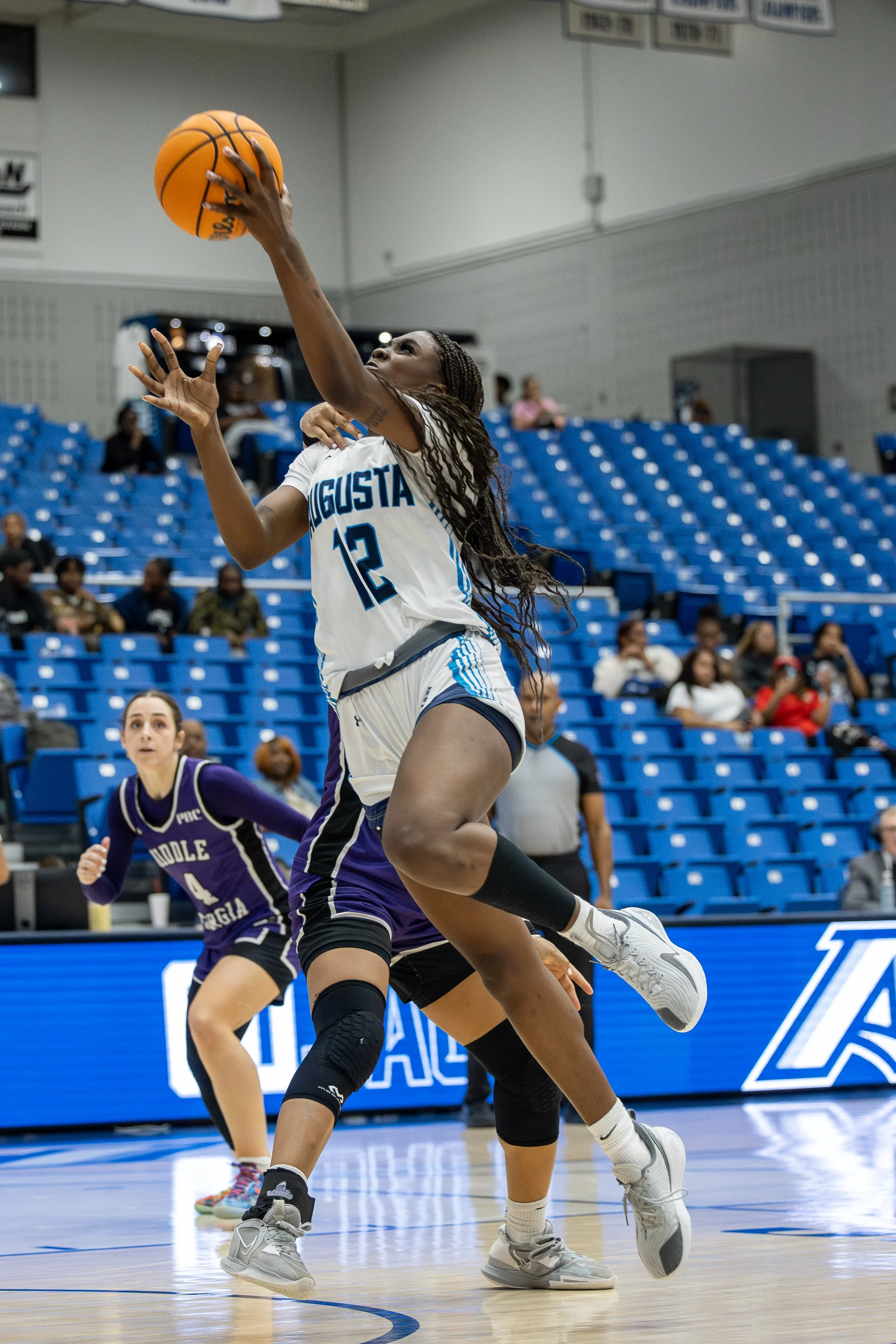  Amari Jackson (12) goes up for a layup over the defense of Middle Georgia. (photo by Lydia Williams/the Bell Ringer) 