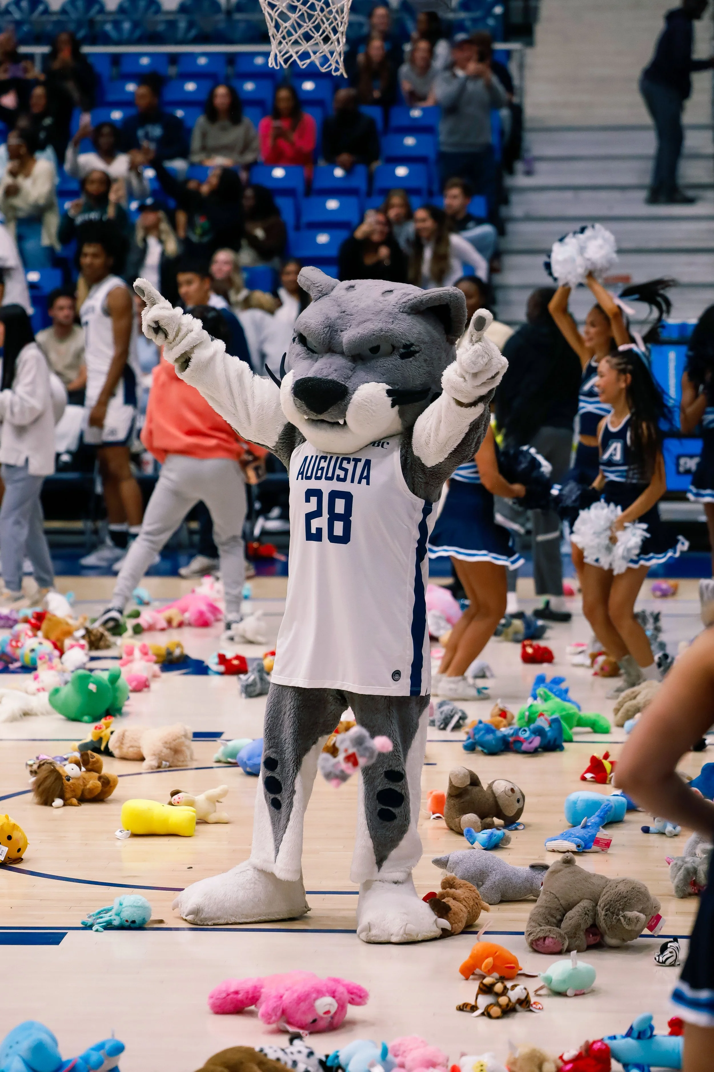  Augustus embracing the stuffed animals (Photo by Lydia Williams/The Bell Ringer). Photo at the top of the screen is Augustus embracing the stuffed animal toss (Photo by Jaxon Garner/The Bell Ringer). 