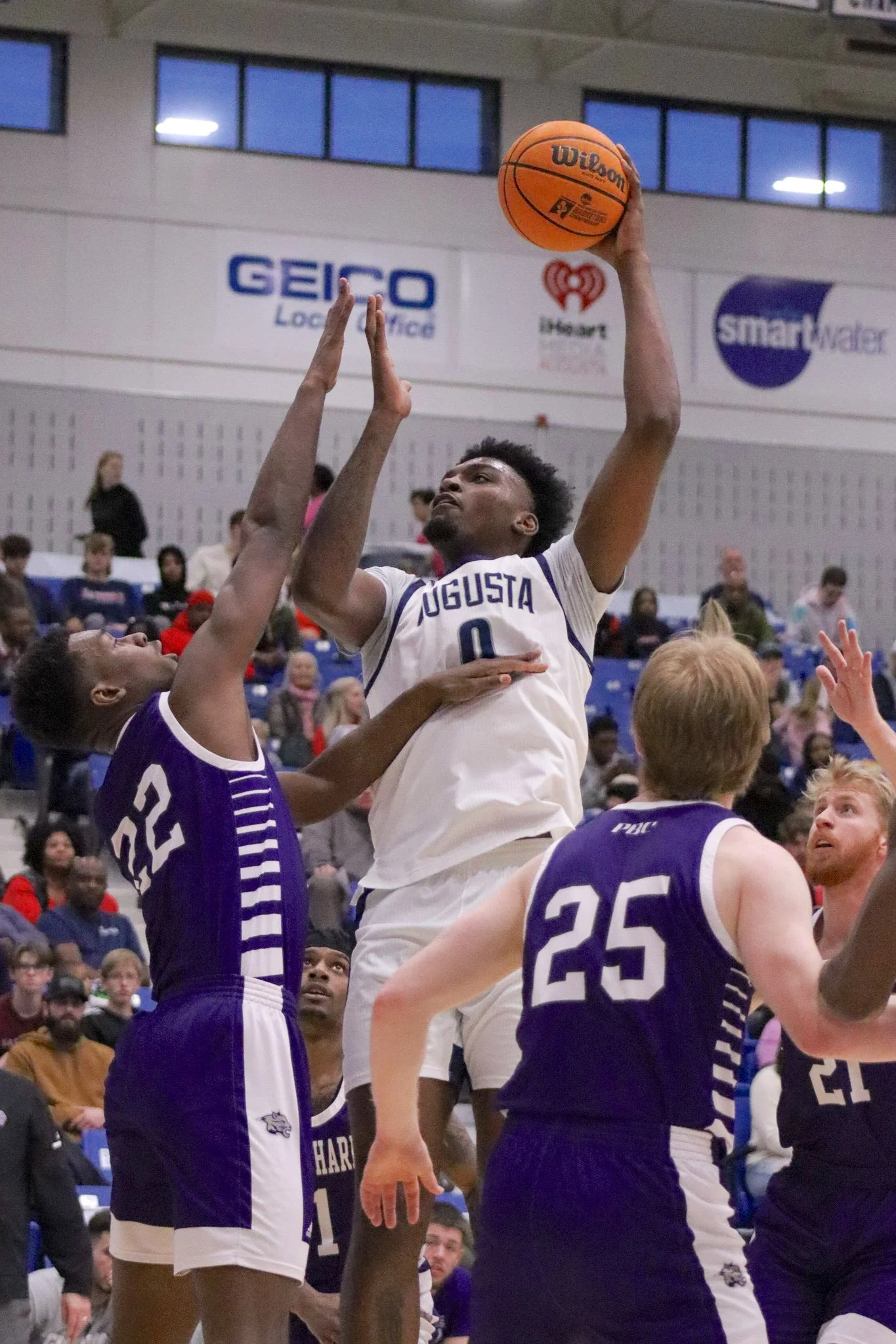  Tyshaun Crawford (0) goes up for two of his 31 points in the Jaguars’ comfortable win over Young Harris. At the top of the page, AU's Autumn Phillips led the way in scoring with 19 points in her team’s win over the Lions. (photos by Madison Keel) 