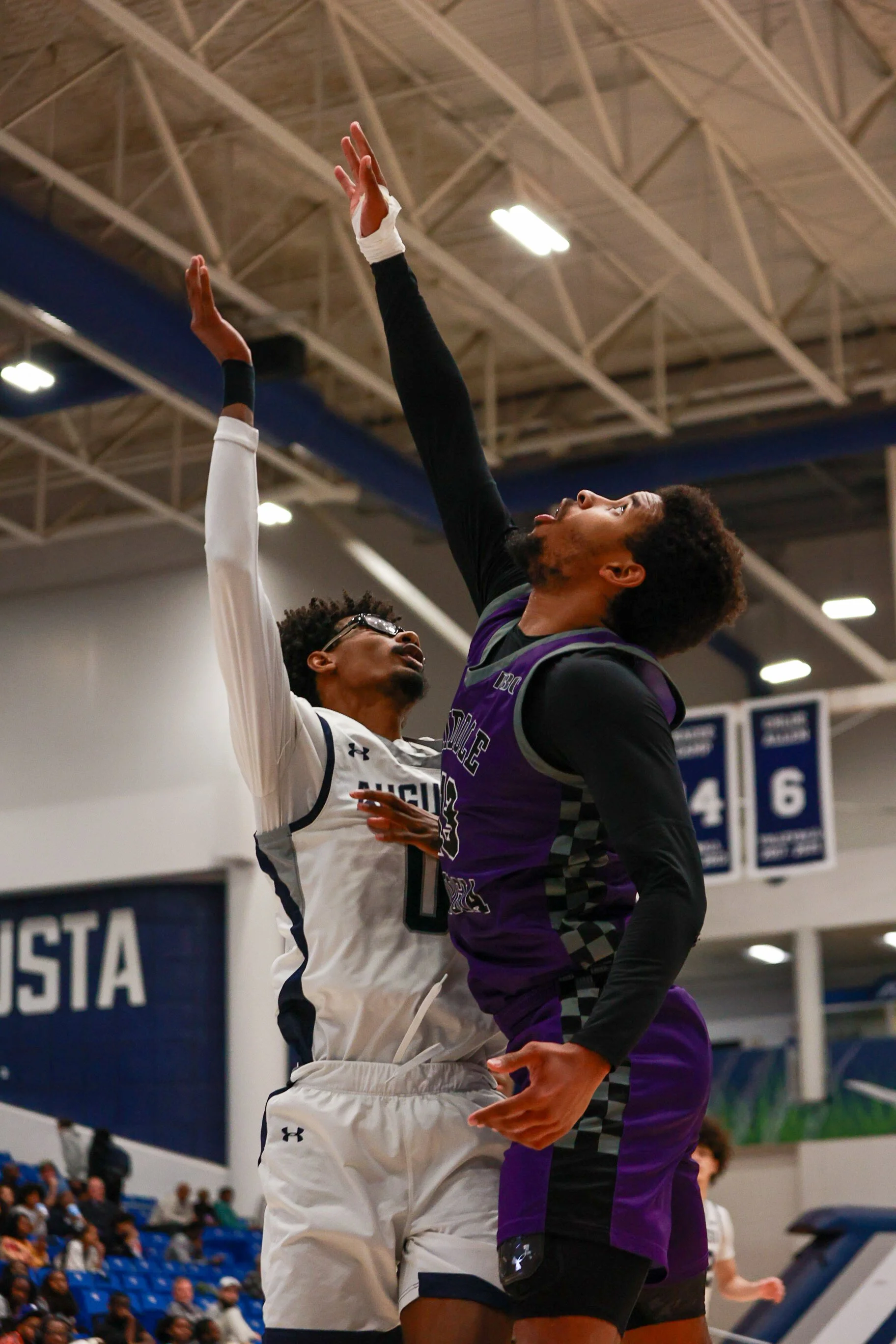  Evan Joyner (0) rises up over the defense for a deuce.   At the top of the page, Tobias Prall (2) shoots a heavily contested three from the corner. (photos by Rodrigo Burgos Avila/the Bell Ringer) 