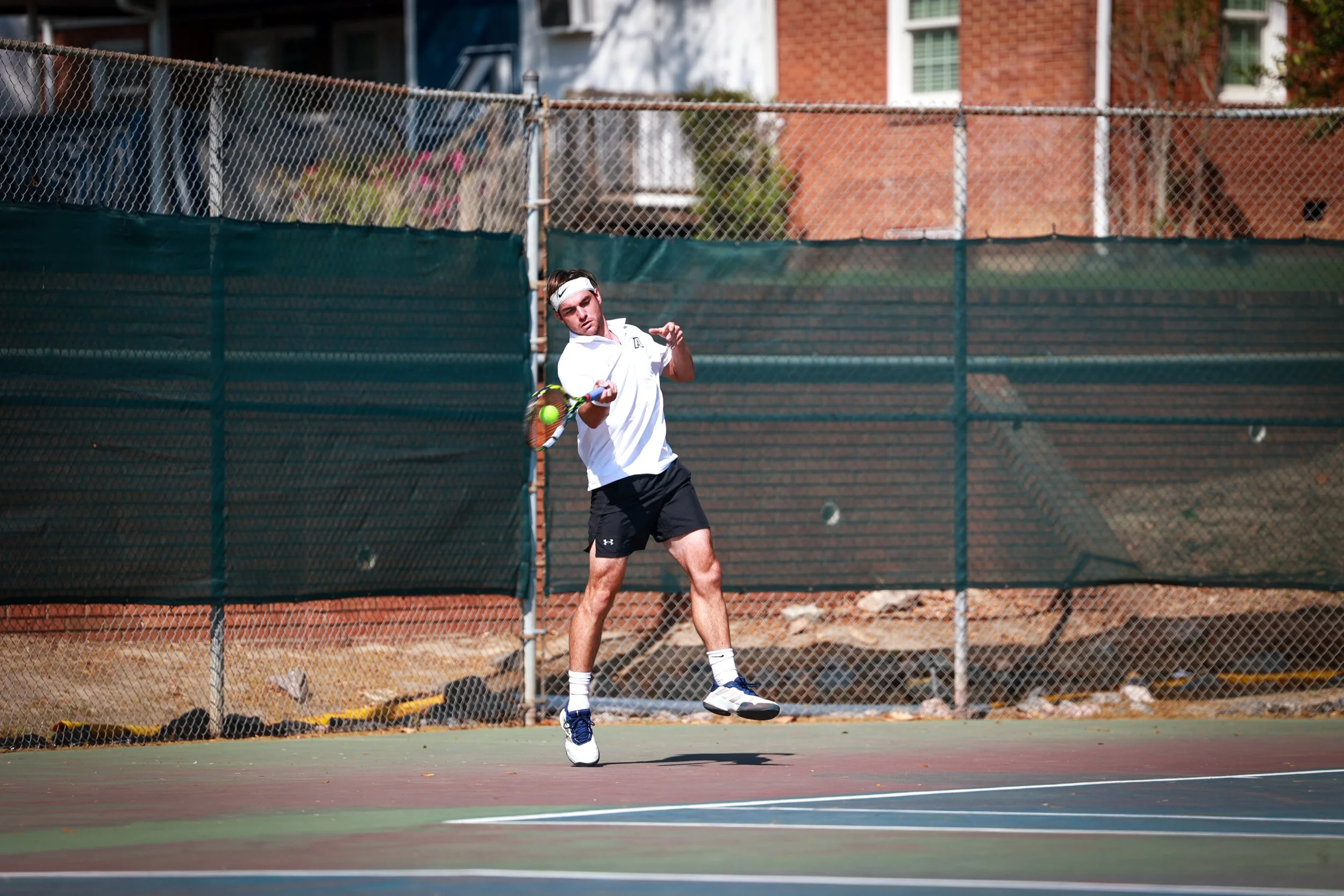  David Perret powers the ball during a rally. Perret delivered against LMU by winning in straight sets. (photo by Rodrigo Burgos Avila/the Bell Ringer) 
