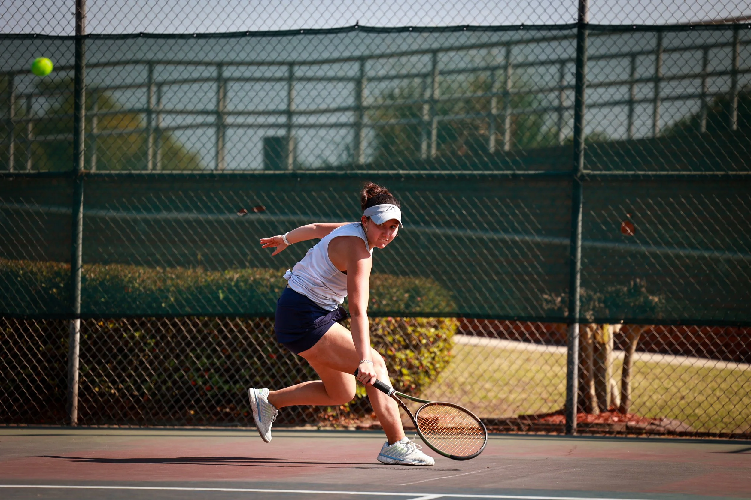  Andrea Gonzalez entends to return the ball. At the top of the page, Arthur Valette kills it at the net. (photos by Rodrigo Burgos Avila/the Bell Ringer) 