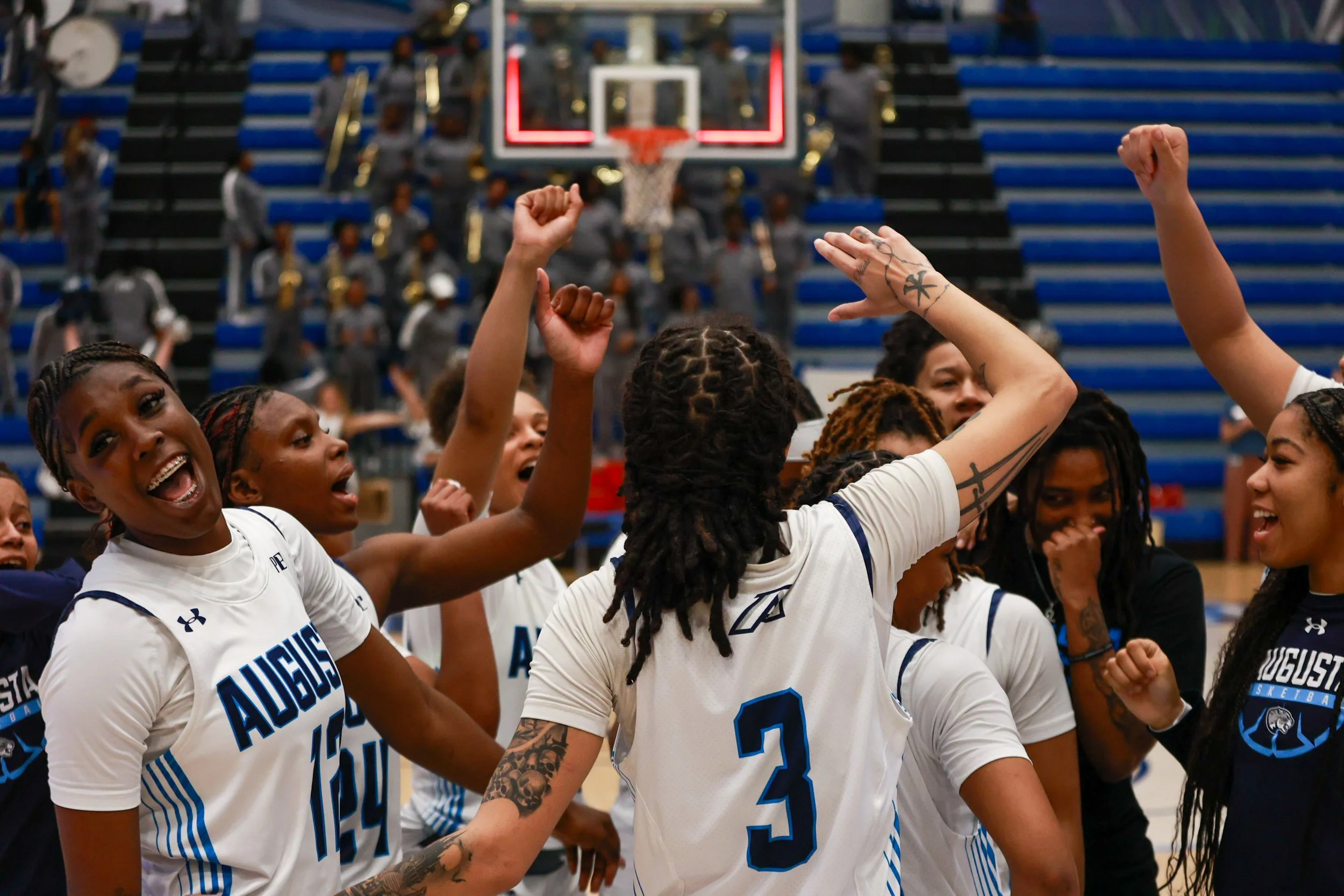  At the top of the page, Quinasia Abercrombie (24) prepares to boxout before a free throw. (photo by Lydia Williams) Below, the team celebrates after the win against the Knights. (photo by Rodrigo Burgos Avila/the Bell Ringer) 