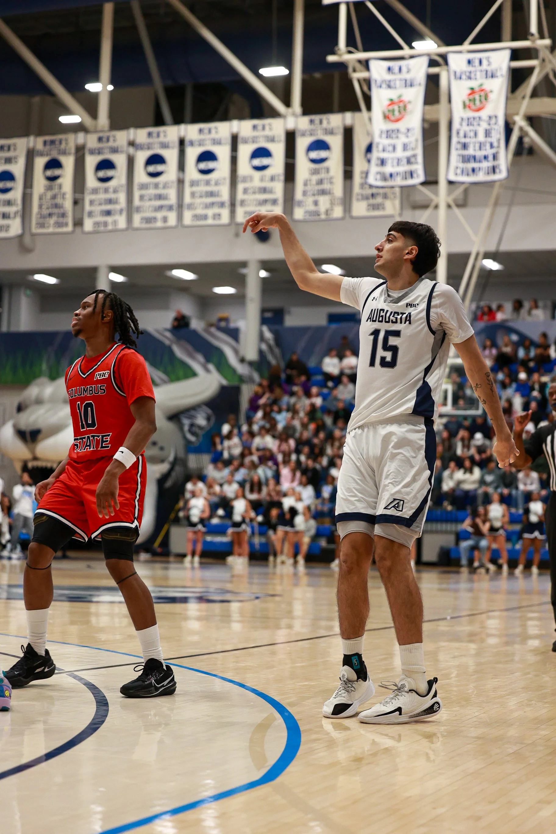  At the top of the page, Elias Palsson (8) rises over the defense to hit one of his four 3-pointers. The sophomore from Iceland finished with a team-high 20 points. Below, Matias Zannoto leaves the follow through after hitting his second 3-pointer of the night. (photos by Rodrigo Burgos Avila/the Bell Ringer) 