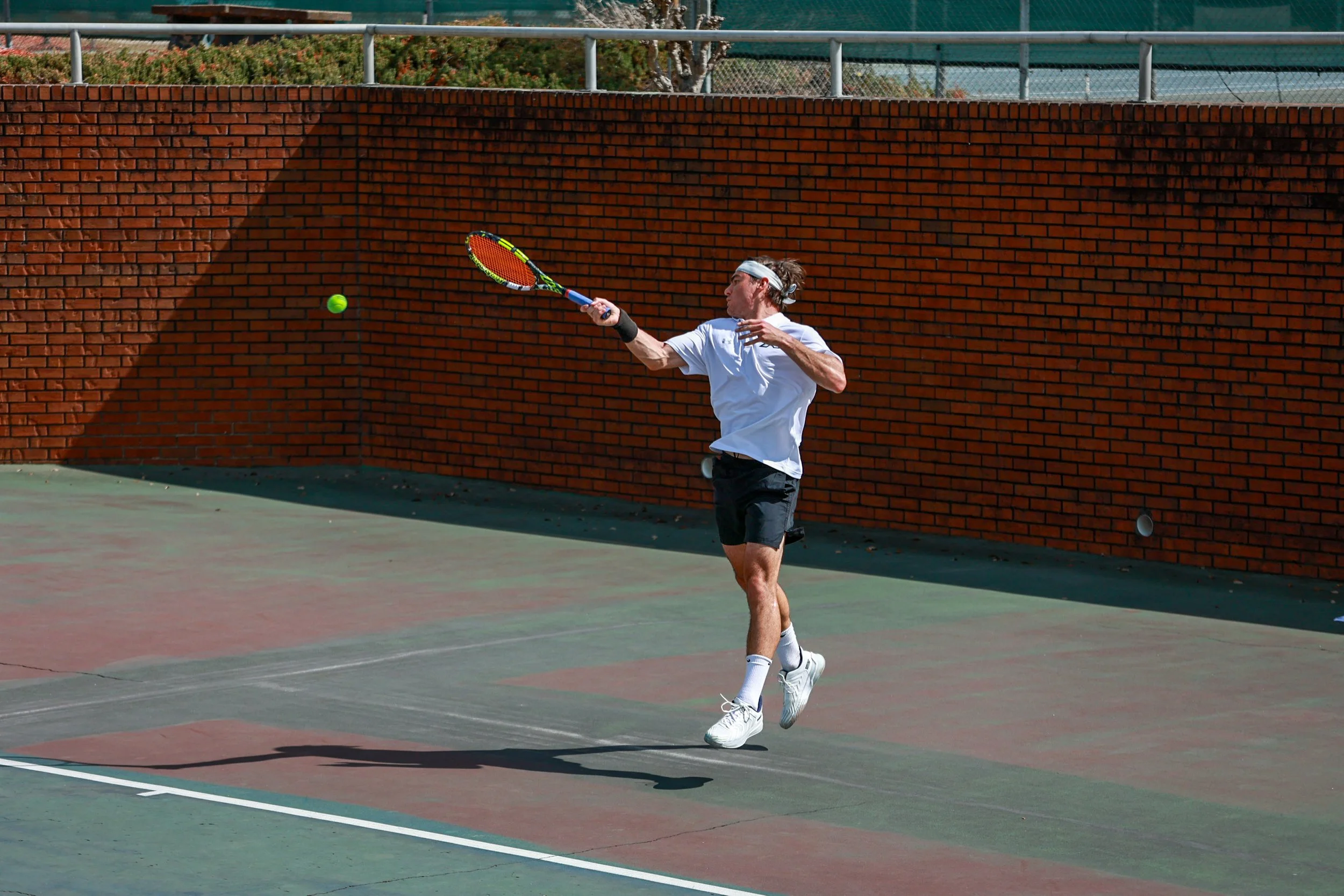 David Perret hits a nice forehand down the line. At the top of the page, Giovanna Patrocinio (right) serves during doubles play with teammate Camila Taborga (left). (photos by Rodrigo Burgos Avila/the Bell Ringer) 