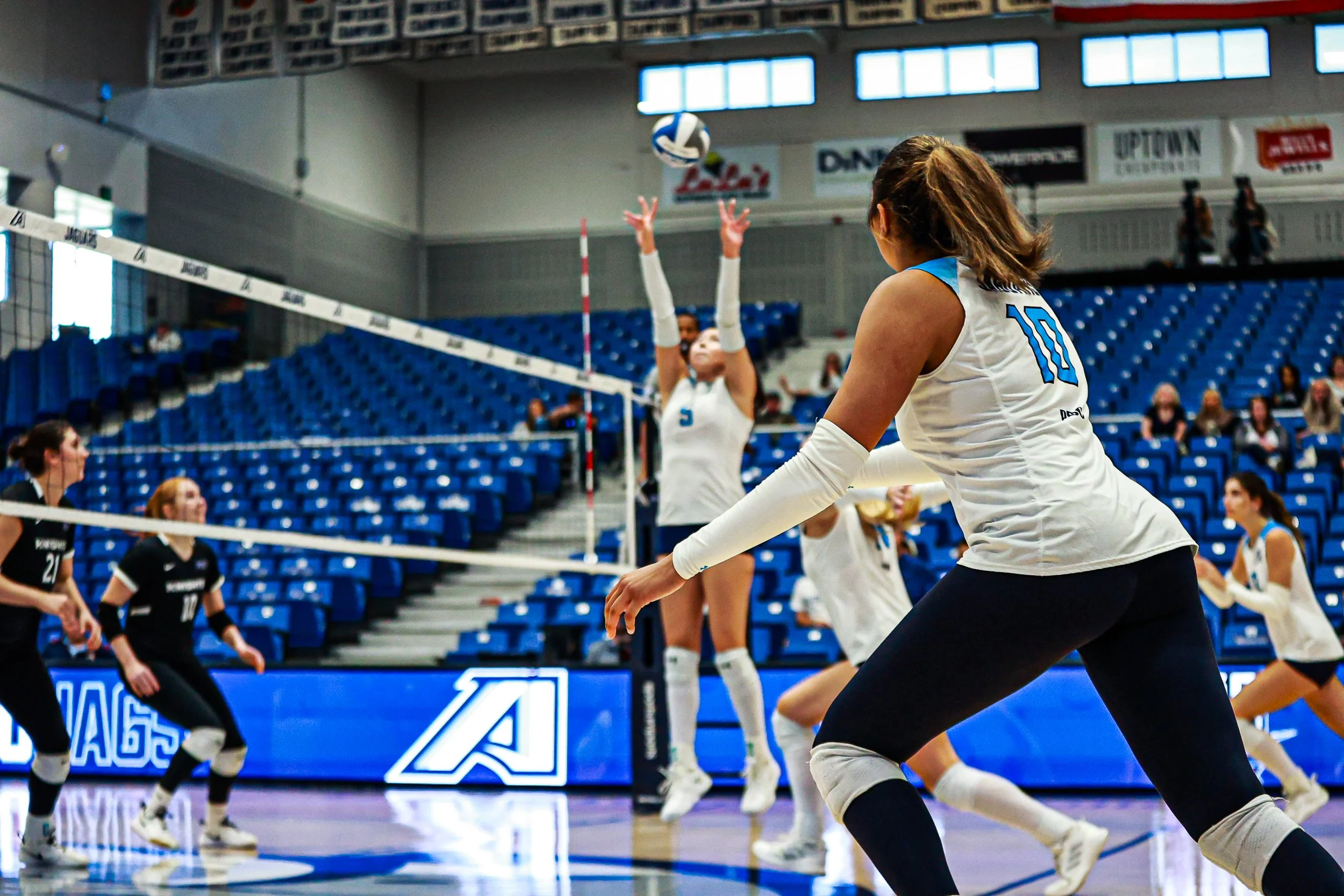  At the top of the page: Ronya Shackleford (10) goes up for one of her 7 kills during the match against the Middle Georgia Knights. Above, setter Mia Saavedra (5) connects with Shackleford (10) for one of her match-high 16 assists. (photos by Rodrigo Burgos Avila/the Bell Ringer) 