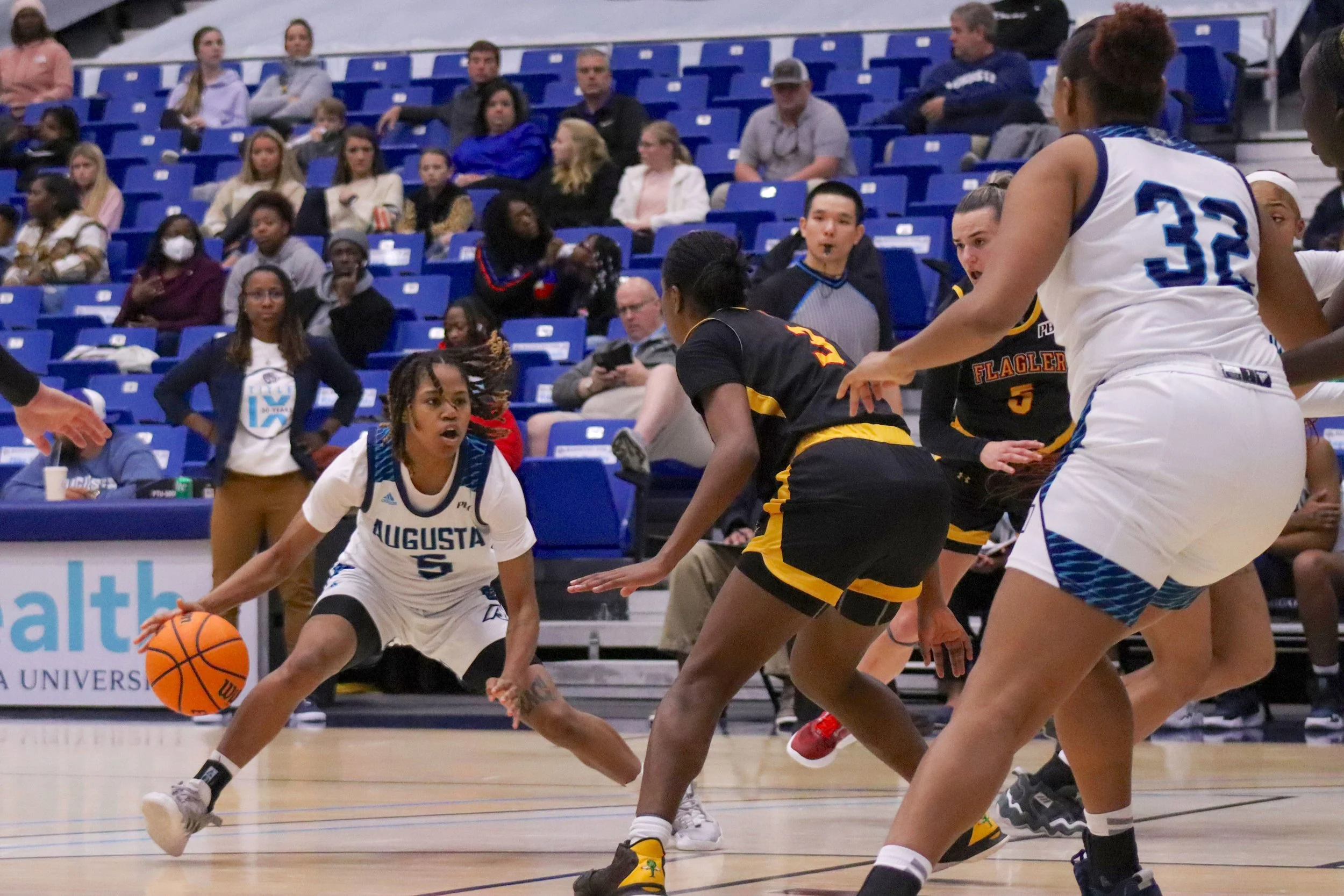  Autumn Phillips (5) shows her ball-handling skills during AU’s 68-52 win over Flagler on Title IX Day. At the top of the page, Tyree Myers drives to the hoop with his left hand for the Jaguars. (photos by Madison Keel) 
