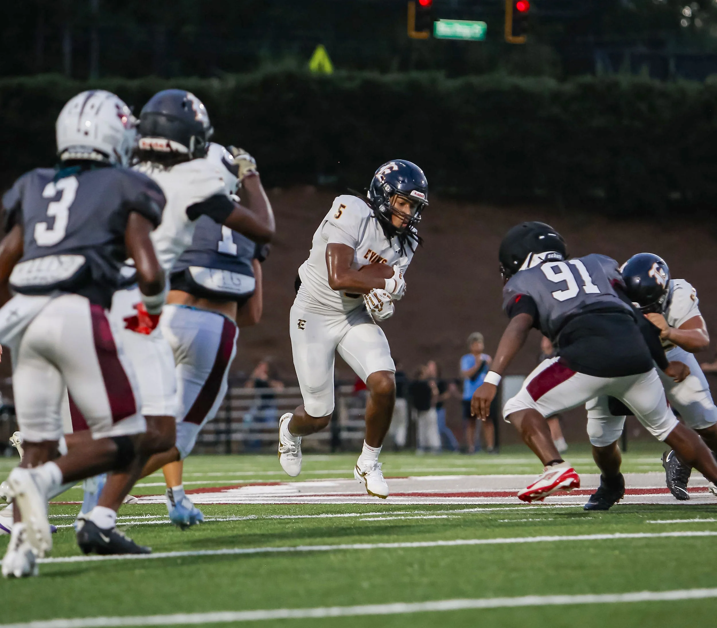  Evans running back Alejandro Moss finds a hole in the Lakeside line as Panther defensive lineman Juvondric Hicks (91) pursues. (photo by Brelynn Crewe/the Bell Ringer) 