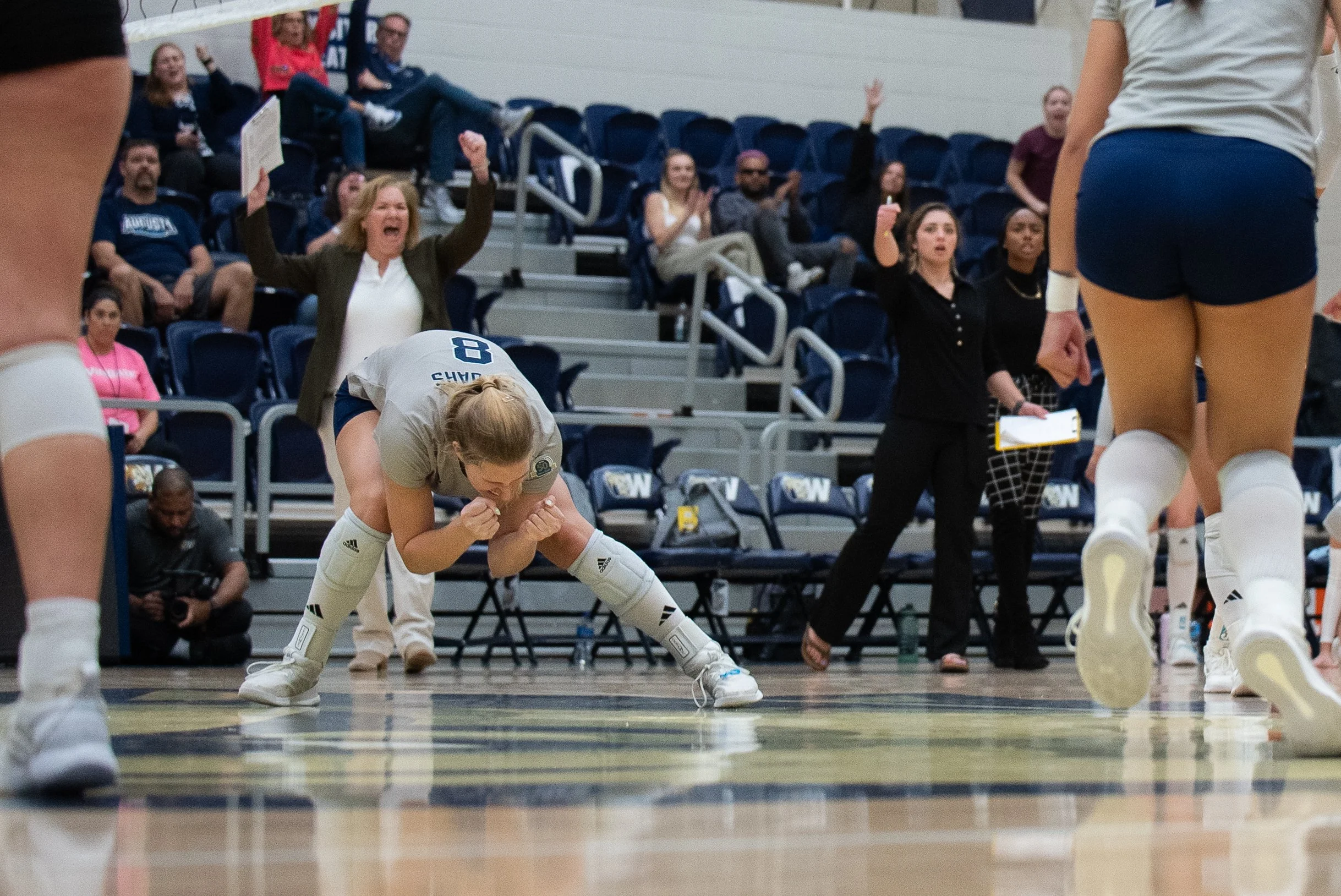  Sophia Kruczko (8) reacts to an AU point in the Southeast Region final against Anderson University. Jaguar Coach Sharon Quarles (behind Kruczko) cheers on the play of her team. (photo by Rachel Carman) 