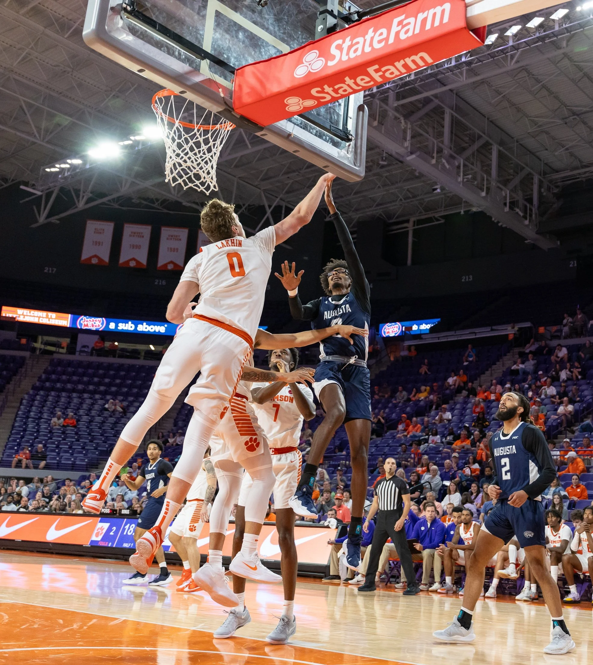  AU’s Evan Joyner (0 in blue) goes up for shot over Clemson’s Viktor Lakhin (0 in white) during the Tigers’ victory over the Jaguars in an exhibition game at Littlejohn Coliseum. (photo by Paula Toole/AU Athletics) 