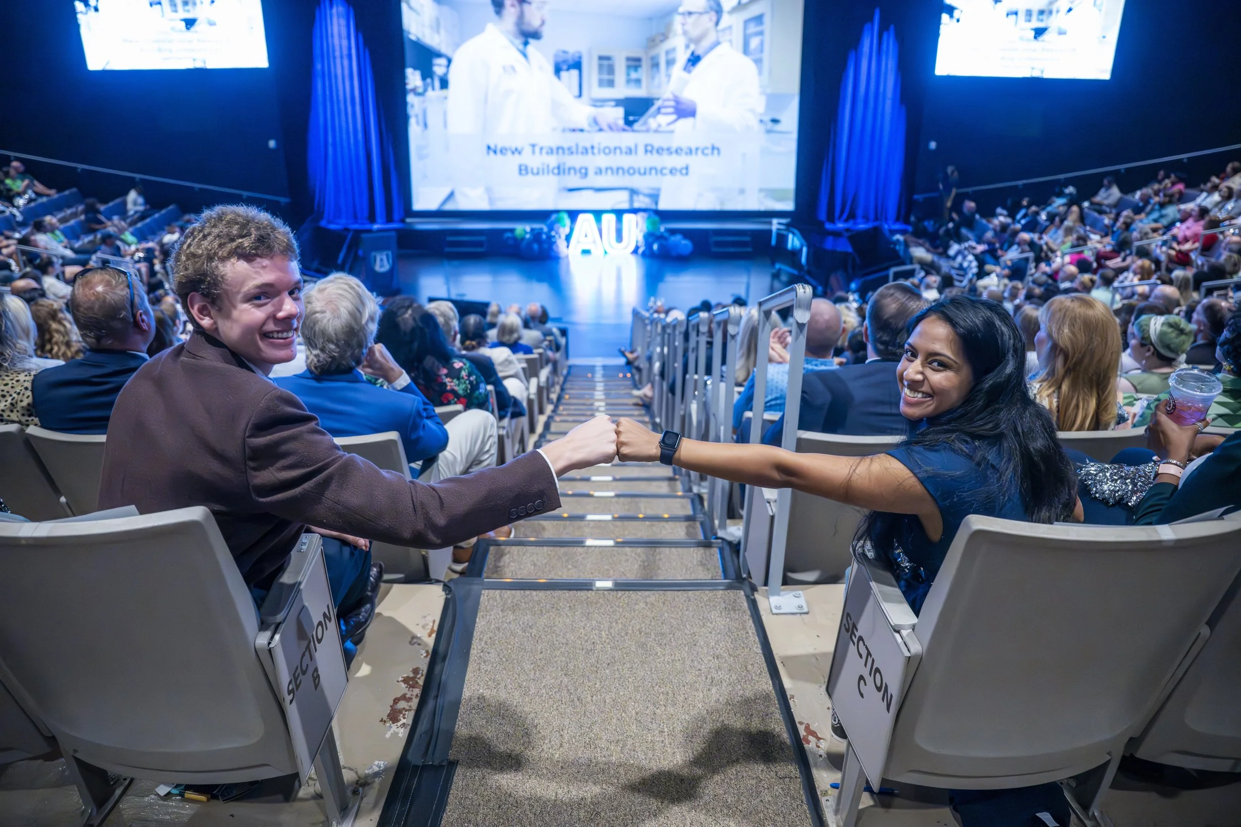 Puja Punukollu (left) and Undergraduate SGA President John Blalock taking part in President Russell T. Keen’s Fall 2025 Kickoff in the Maxwell Theatre. At the top of the page, Punukollu addresses the Class of 2029. (photos by Mike Holohan/DCM) 