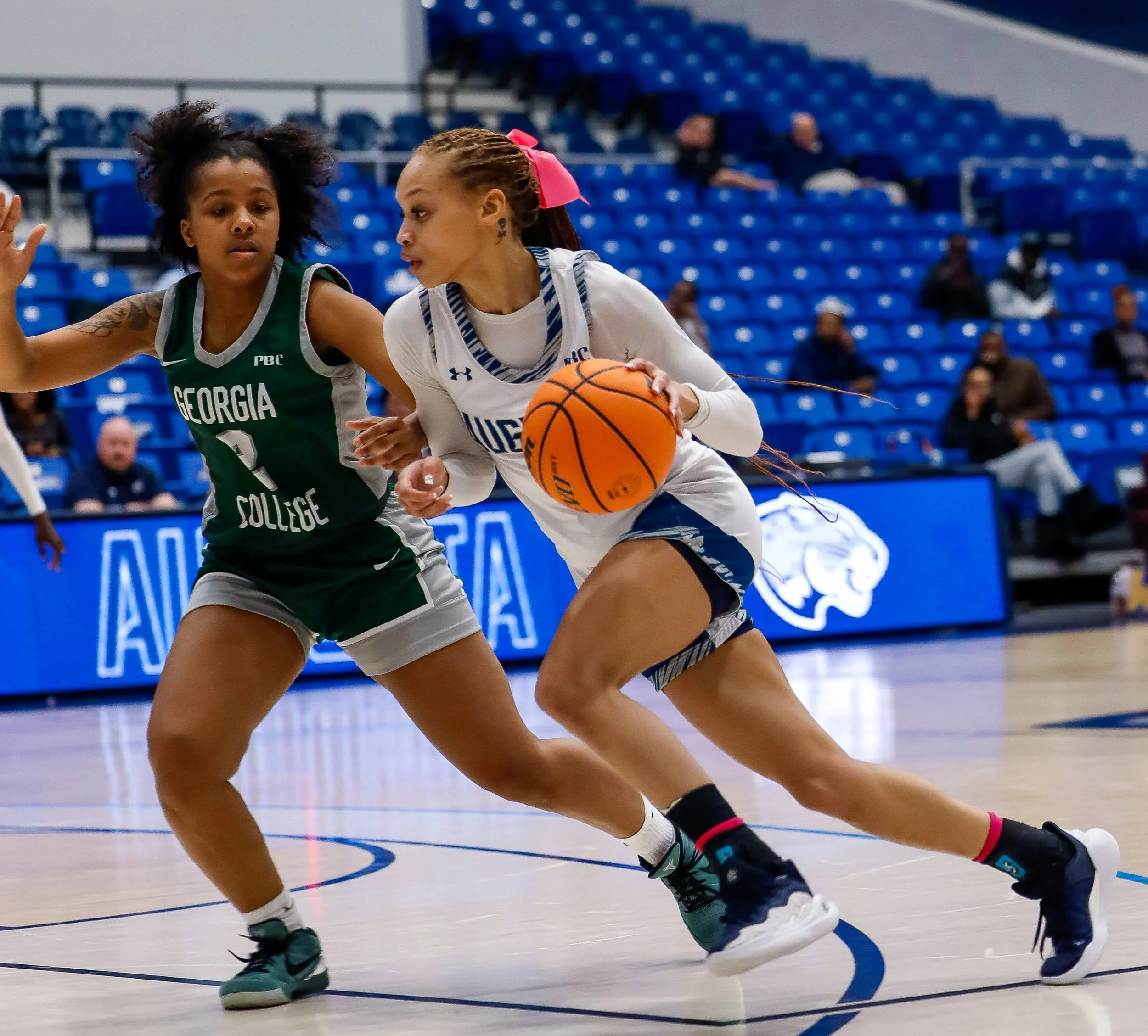  Mone Florence (R) drives to the hoop during her playing career for the Jaguars. At the top of the page, Florence dribbles into the frontcourt during a Peach Belt Conference game. (Photo by Lydia Williams/the Bell Ringer) 
