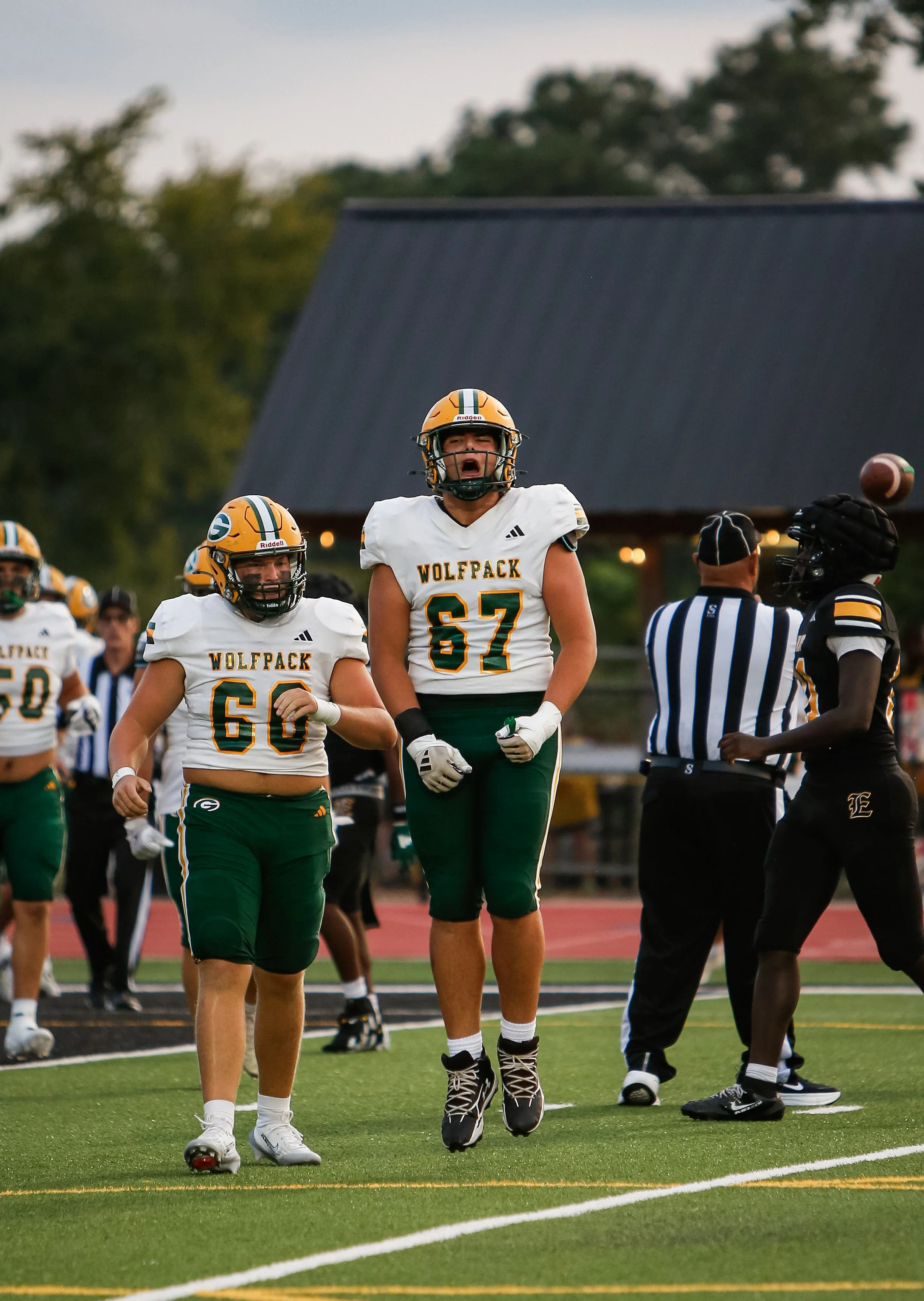  Greenbrier’s Gavin Baxley (67) and Wyatt Jones celebrate the Wolfpack’s 42-35 victory over rival Evans. At the top of the page, Brennen Bjorkman had a dominant night for Greenbrier with 181 yards rushing and five touchdowns. (photos by Brelynn Crewe/the Bell Ringer) 