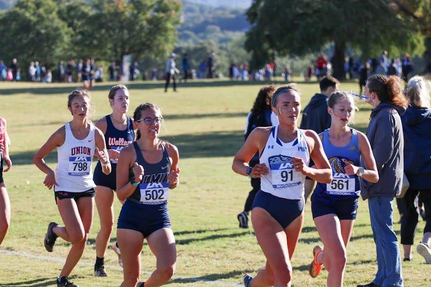  AU’s Cassie Lagan (91) shows her form during the UAH Chargers Inviational in Huntsville, Ala. At the top of the page, the Jaguar women start the race with Riley Triplett (99) at the front. (photos by Tommy Triplett, special to the Bell Ringer) 