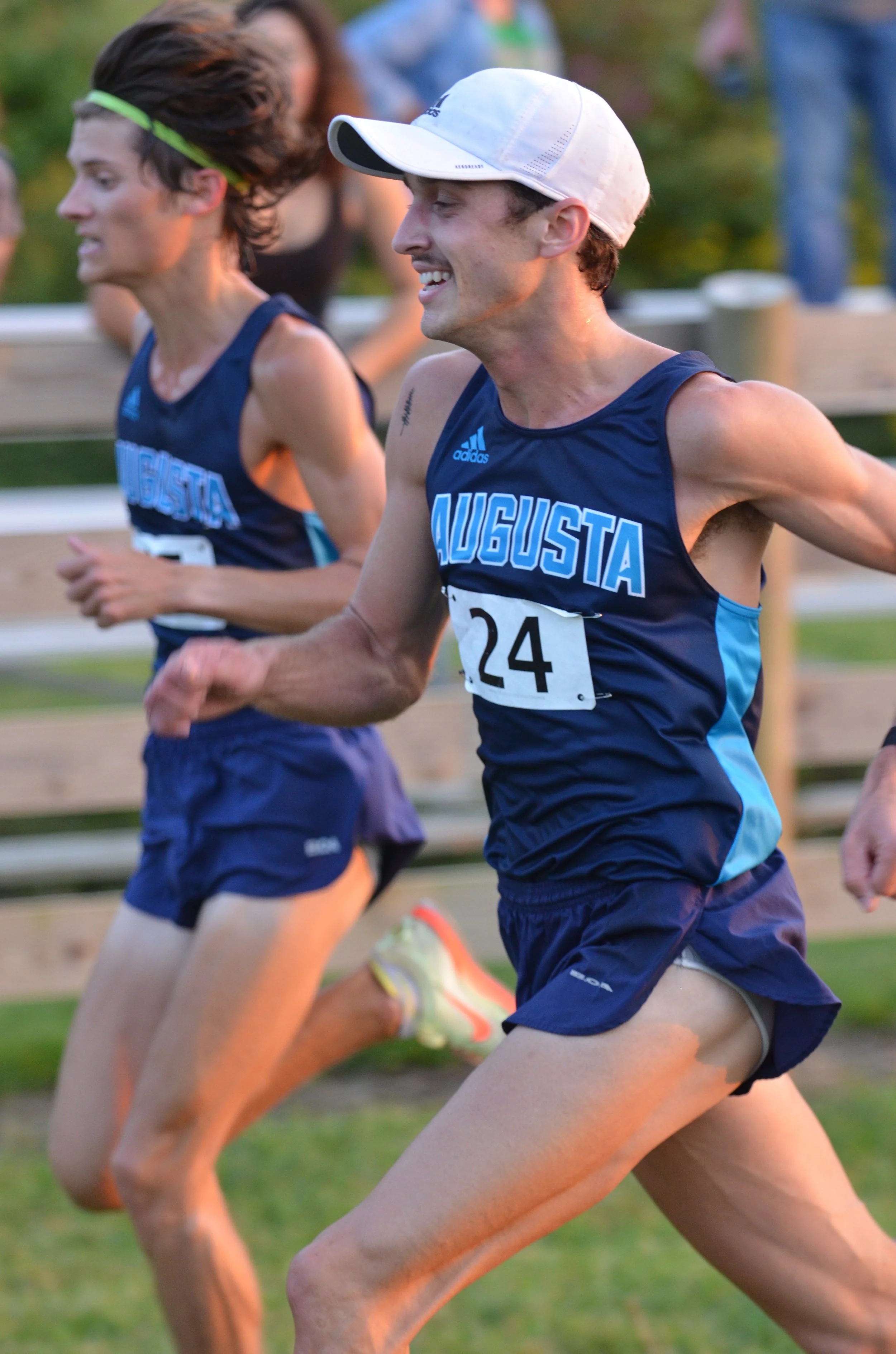   Hans Troyer (24) and teammate Patrick Motes (left) run for the finish line. Motes edged Troyer by three-tenths of a second for 20th place in the Virginia Tech race. At the top of the page, Riley Triplett (39) and Madison Kennedy (30) lead AU’s charge. (photos by David Troyer, special to the Bell Ringer) 