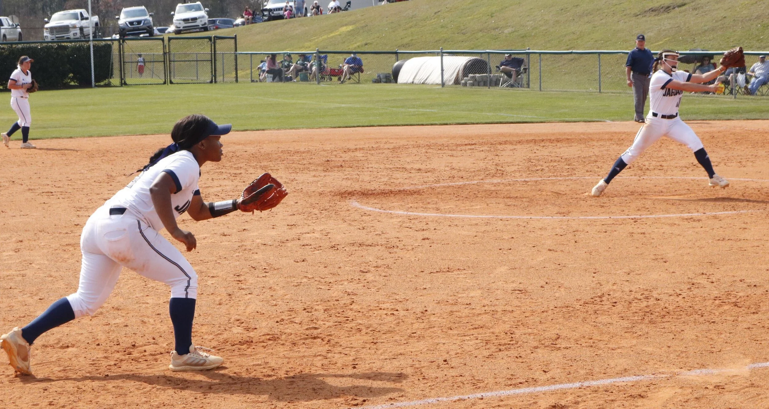  Third baseman xxx Luke (L) prepares to field as teammate Mary Tillman pitches for the AU softball team. At the top of the page, Tillman shows her form en route to a one-hitter in a 10-0 win over USC Aiken. (photos by Chris Rickerson) 