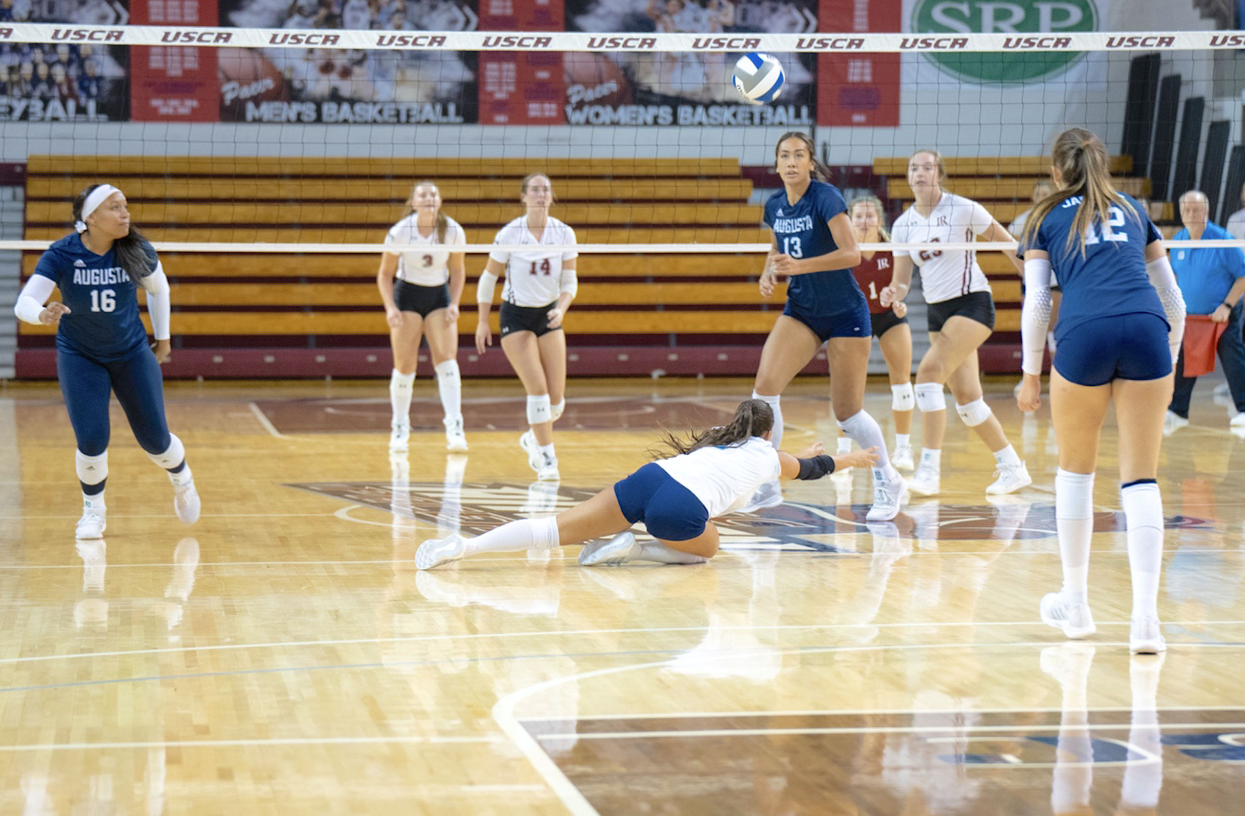  Jaguar libero Dariana Luna hustles to keep the ball in play as teammates Jazmyn Wheeler (16), Jada Suguturaga (13) and Mikayla Kline (12) watch during the Pacer Invitational. (photo by Rachel Carman) 