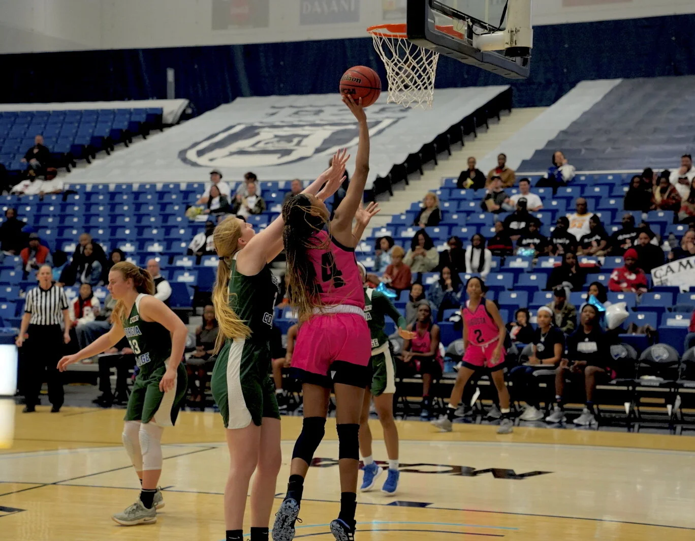  Kennedi Manning (24) goes up for a layup; she totaled nine points and eight rebounds in the win over Georgia College. At the top of the page, Zairya West (0) led the way for AU with 19 points. (photos by Carlos Rodriguez) 