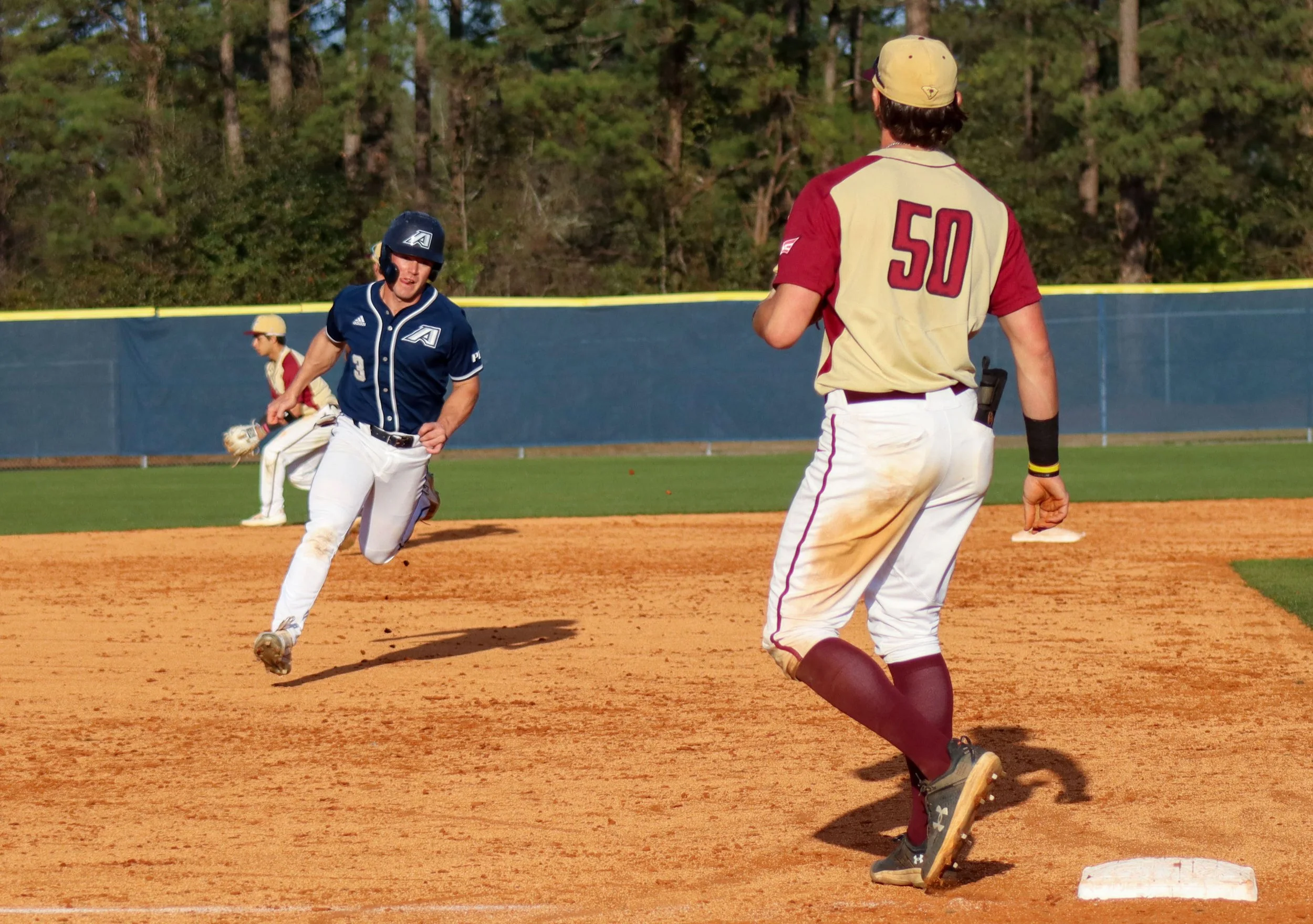  AU’s Pat Galvin (3) heads to third base on an afternoon when he had two hits and a run scored. At the top of the page, Kyle Lodise swings away for the Jaguars, who dropped a 7-6 decision to Erskine. (photos by Madison Keel) 
