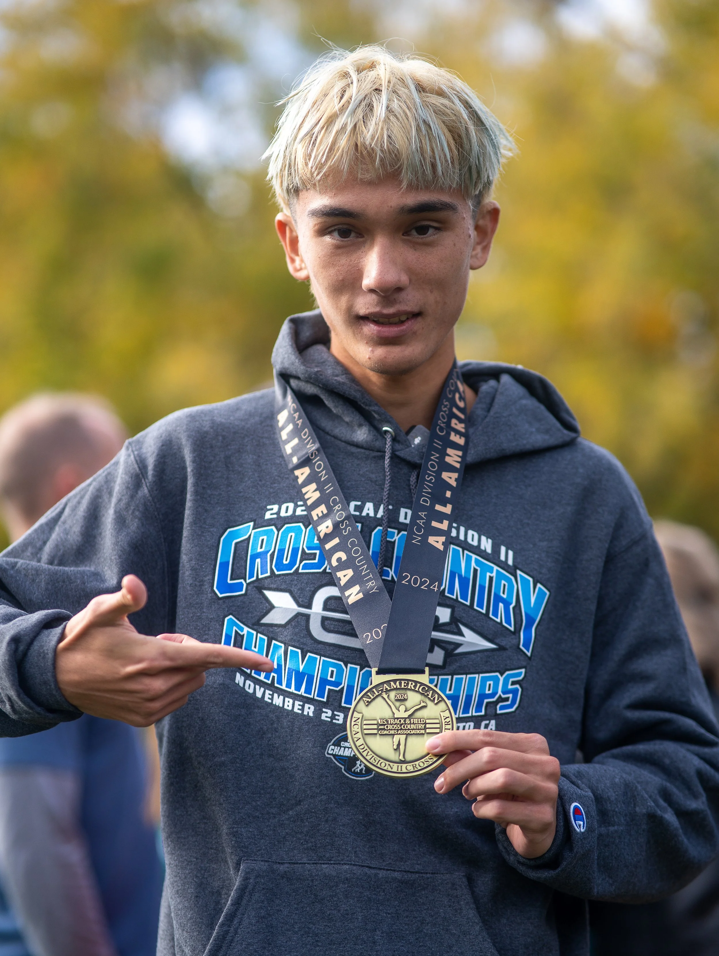  AU senior Jordan Robertson with his all-American medal at the NCAA Division II cross-country championships. (photo courtesy of AU Athletics) 