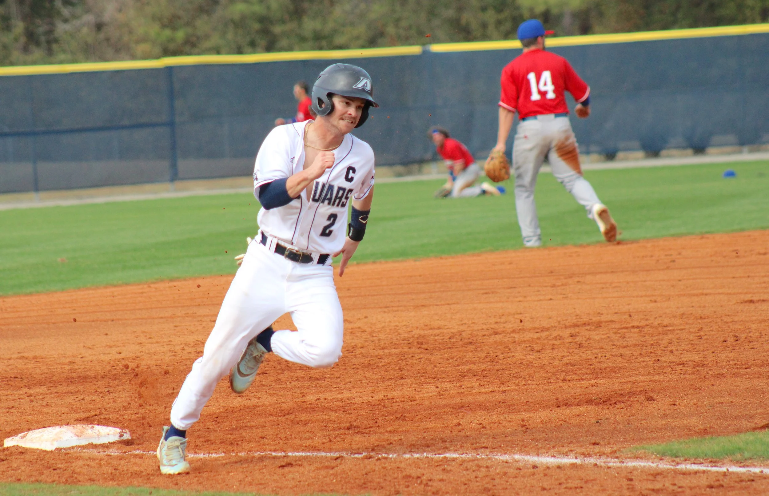  Augusta’s Mason Robertson (2) rounds third to score on a day when he had two hits, including a grand slam. At the top of the page, Pat Galvin (3) shows his form at the plate; he went 4-for-5 with one RBI against West Georgia. (photos by Chris Rickerson) 