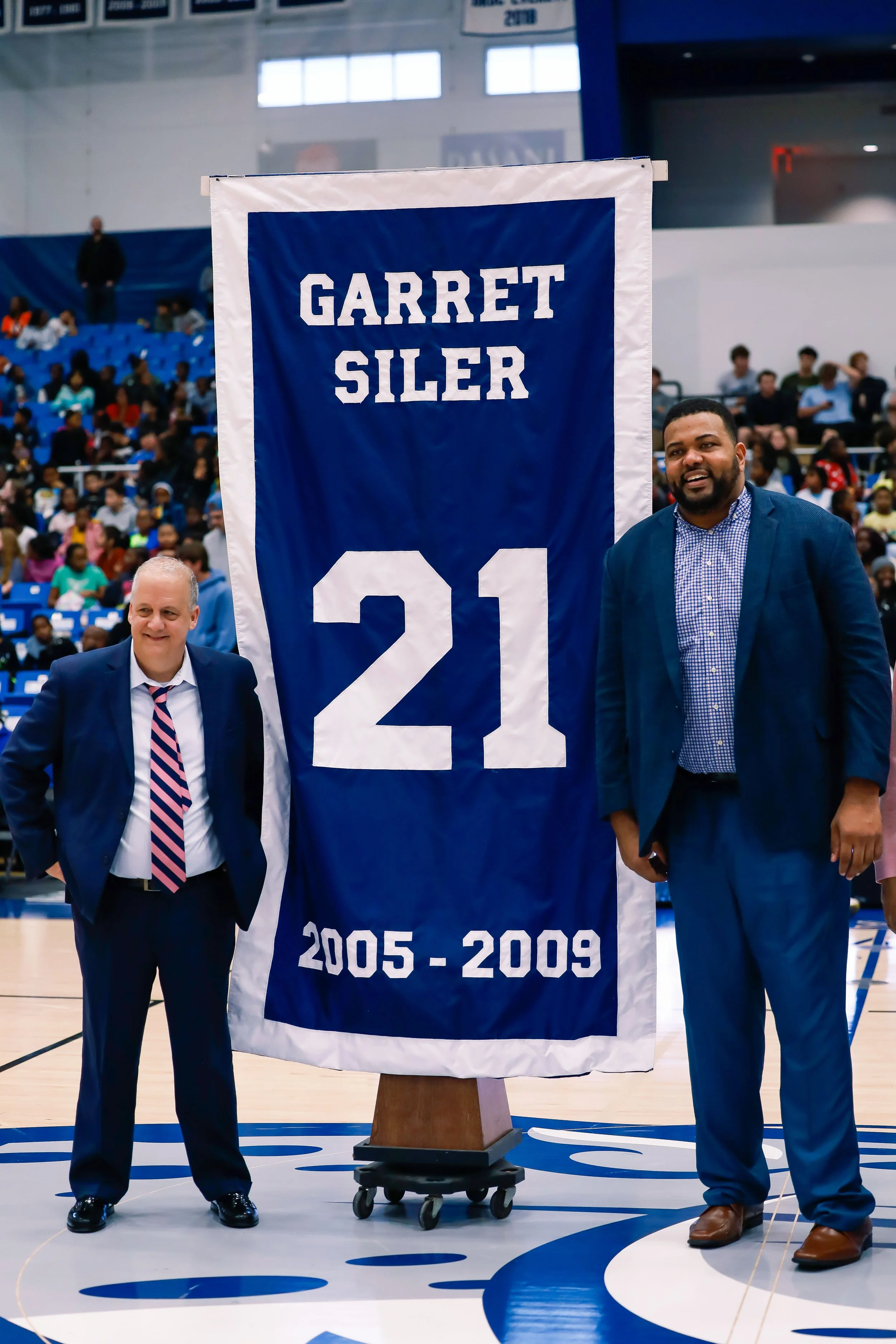  AU Assistant Coach Garret Siler (R) watches as his No. 21 jersey is retired. Siler played for Jaguar Coach Dip Metress from 2005-2009 and led Augusta to the national title game in 2008. (photo by Lydia Williams) 