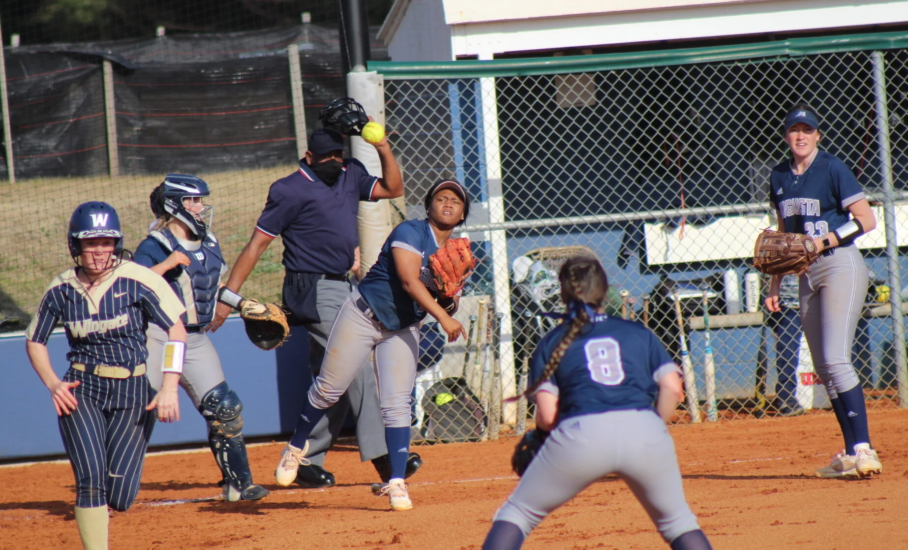  AU freshman Aliyah Luke throws out a runner to first baseman Olivia Biles (8), as Bella Fernandez (23) watches. At the top, Jaguar junior Jakayla Sullivan tags a runner out at second base. (photos by Carlos Rodriguez) 