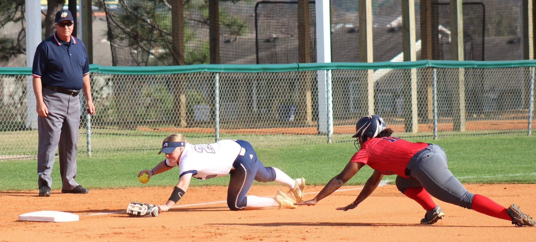  AU third baseman Shelbie Summerlin (20) goes for the tag on the Pacers’ Brianna Dow (12) in the Peach Belt Conference softball game. (photo by Chris Rickerson) 