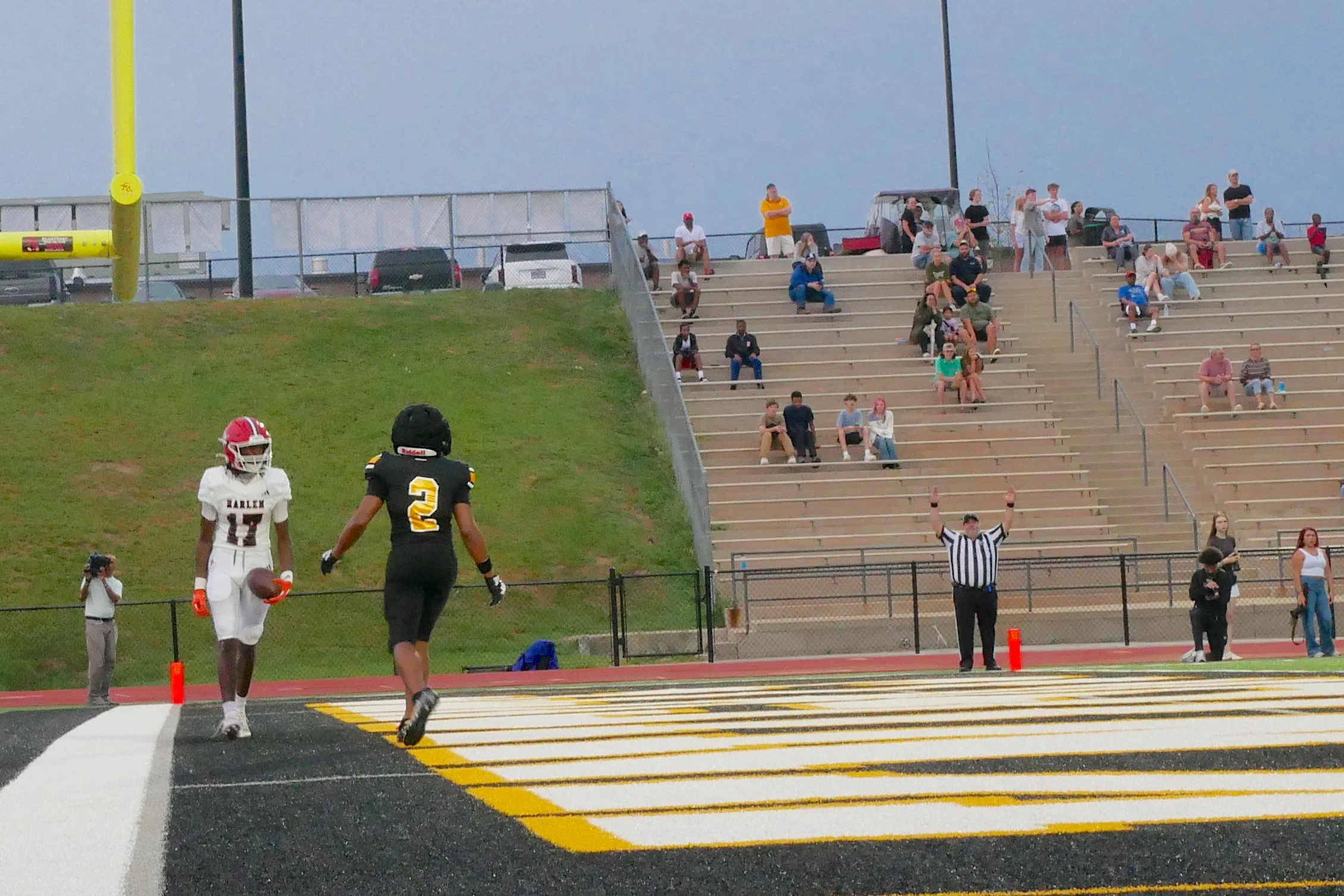  Harlem’s Tae Hudson (17) walks in the back of the end zone just after he caught a touchdown pass from Hayden Youmans in Evans’ 37-20 win over the Bulldogs on Friday night, Aug. 21. Brycen Gault (2) defends for the Knights. Gault would have an outstanding opening night with 246 yards rushing and two interceptions, one for a 74-yard pick six. At the top of the page, Harlem’s Youmans (12) gets set to throw while Keaton Tillery (34) blocks for the Harlem quarterback. (photos by Cooper Brady/the Bell Ringer) 
