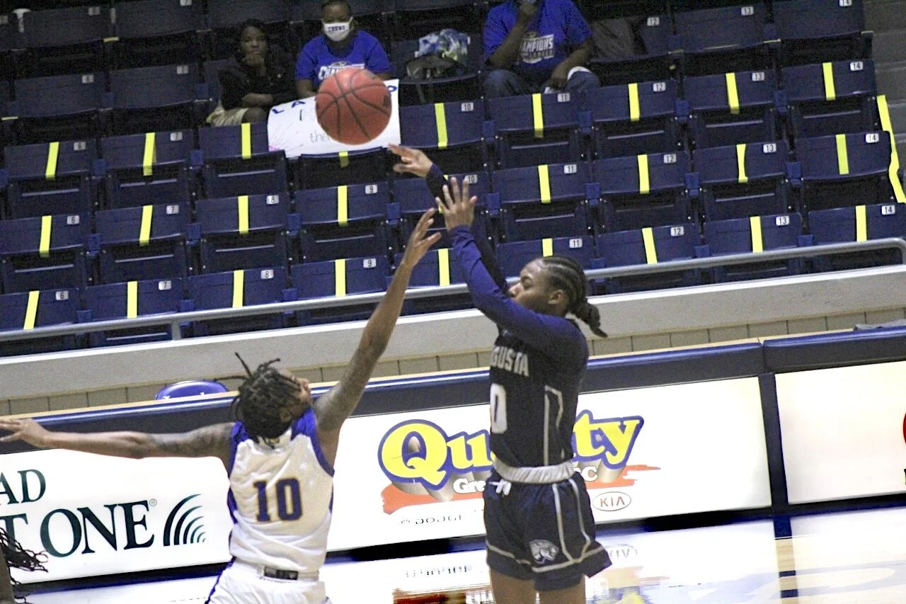  Zairya West (0) goes up for two of her 17 points in AU’s 70-57 loss at Lander University in Peach Belt Conference action. At the top of the page, Kennedi Manning posts up for the Jaguars as Ashleigh Boulin (11) attempts to feed the post. (photos by Carlos Rodriguez) 