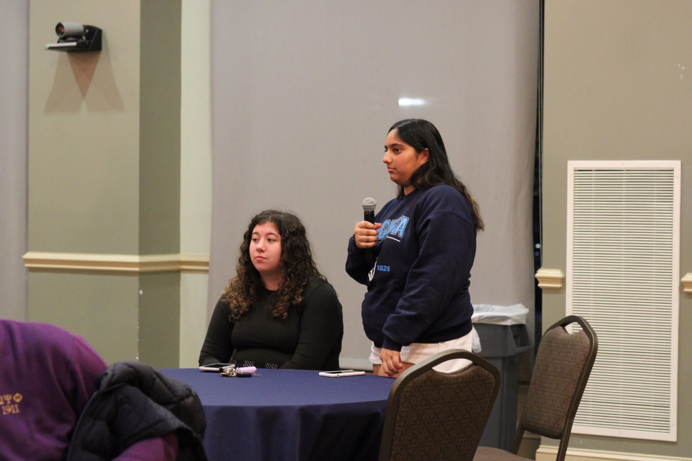 Freshman students Bell Scdoris (left) and Harjot Pandher (right) speak at the listening session on Dec. 6.  (photo by Rakiyah Lenon)  