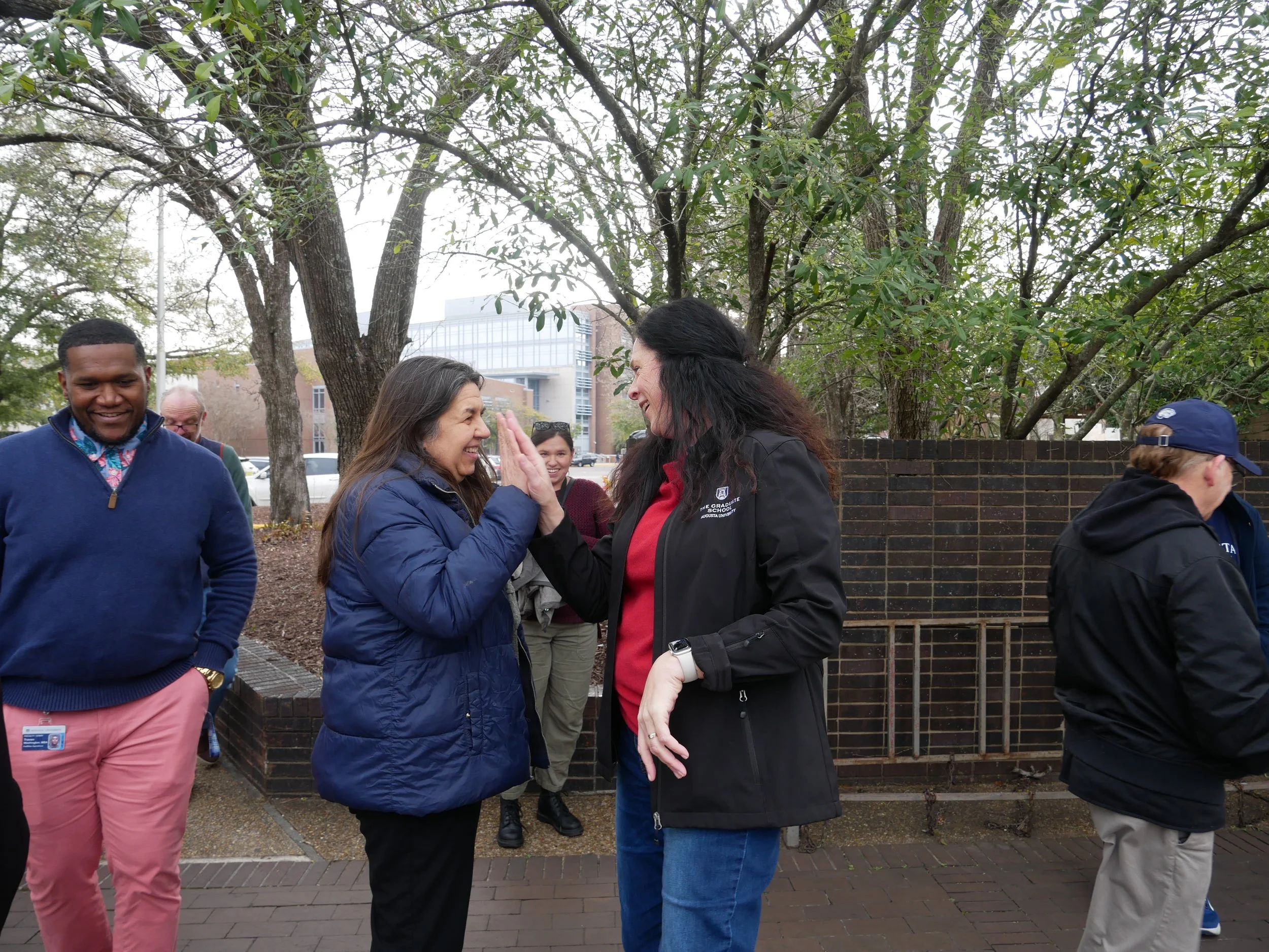  Provost Maggy Tomova and professor Jennifer Sullivan give a high five. (photo by Caelyn Dockal/the Bell Ringer) 