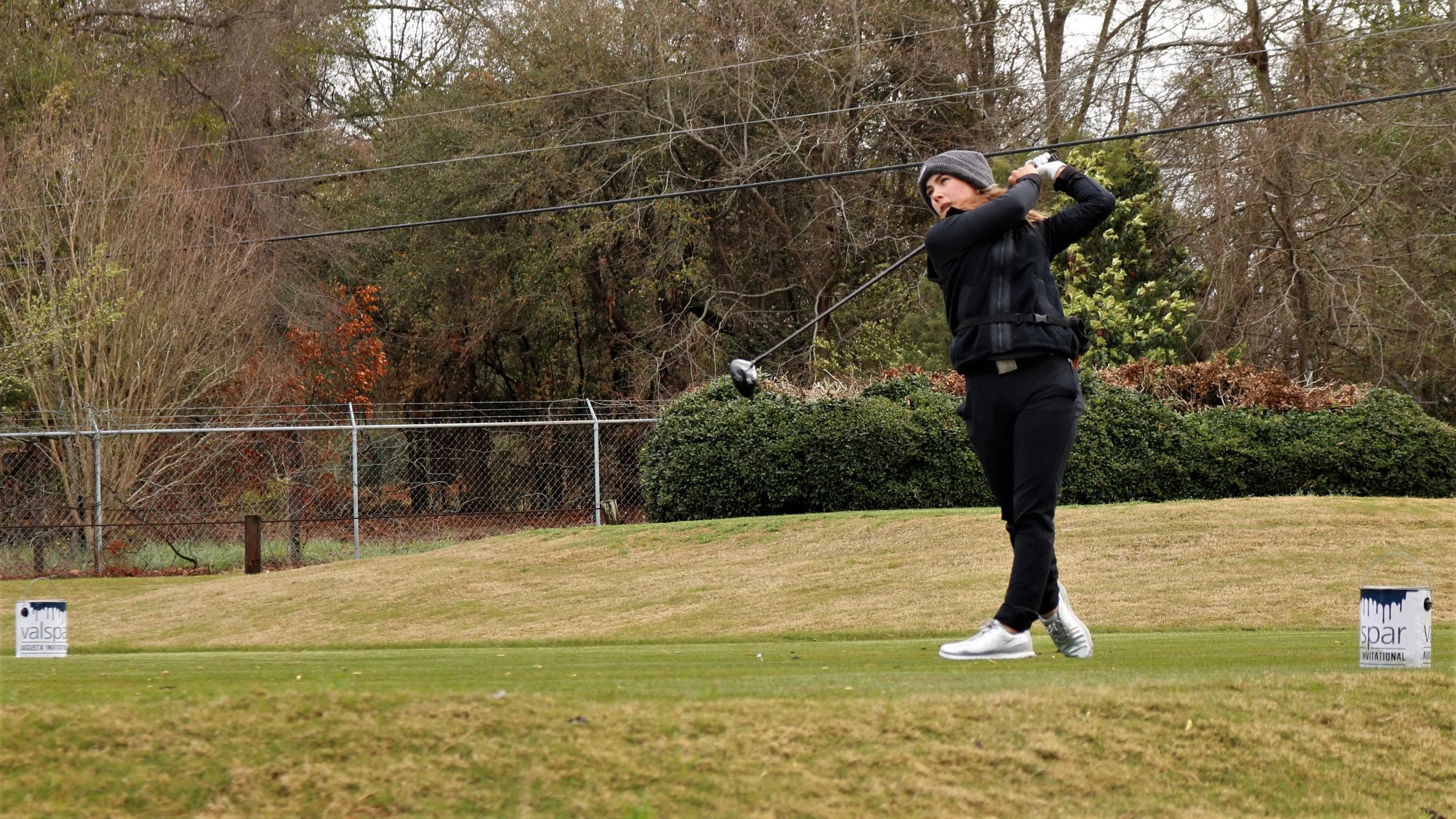 AU freshman Chloe Holder tees off during the Valspar Augusta Invitational. (photo by Madison Keel) At the top of the page, Jaguar senior Natalia Yoko celebrates her individual crown. (photo by Chris Rickerson) 