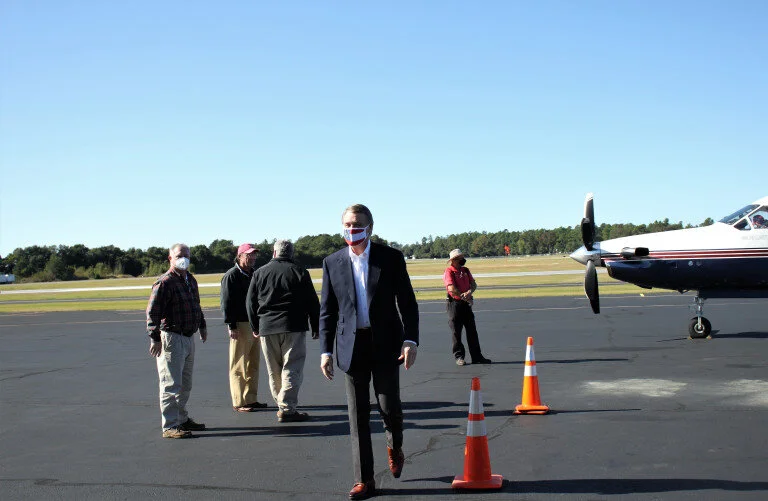   Perdue exits the plane to say hello to the gathered crowd of his supporters. (photo by Haley Knight)  