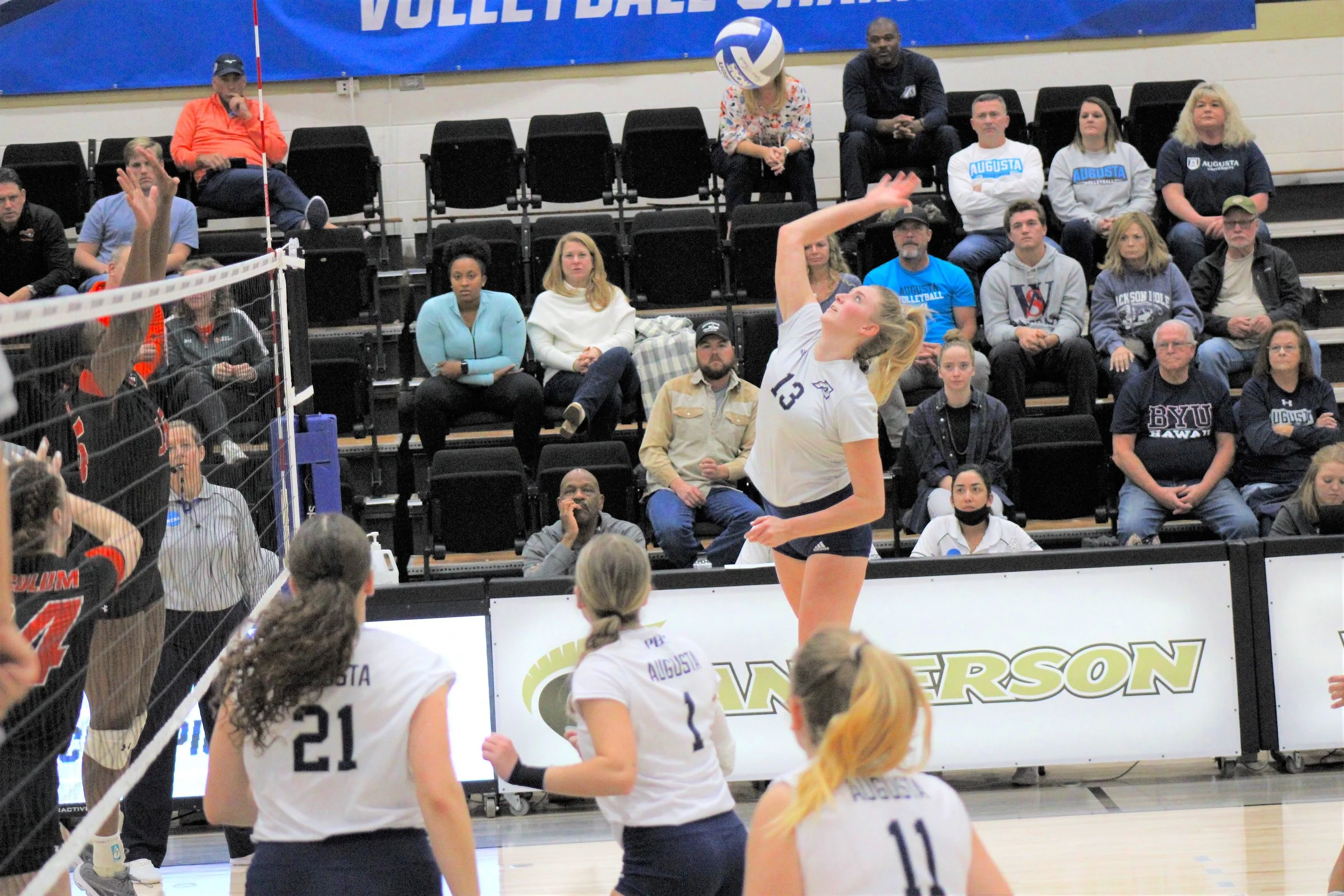  Kylie Martin gets a kill for AU. Once again she was one of the leaders for the Jaguars, now regional champions. At the top of the page, Ally Thees (1), Chloe Allen (6) and Radka Brichakova (11) celebrate for Augusta. (photos by Chris Rickerson) 