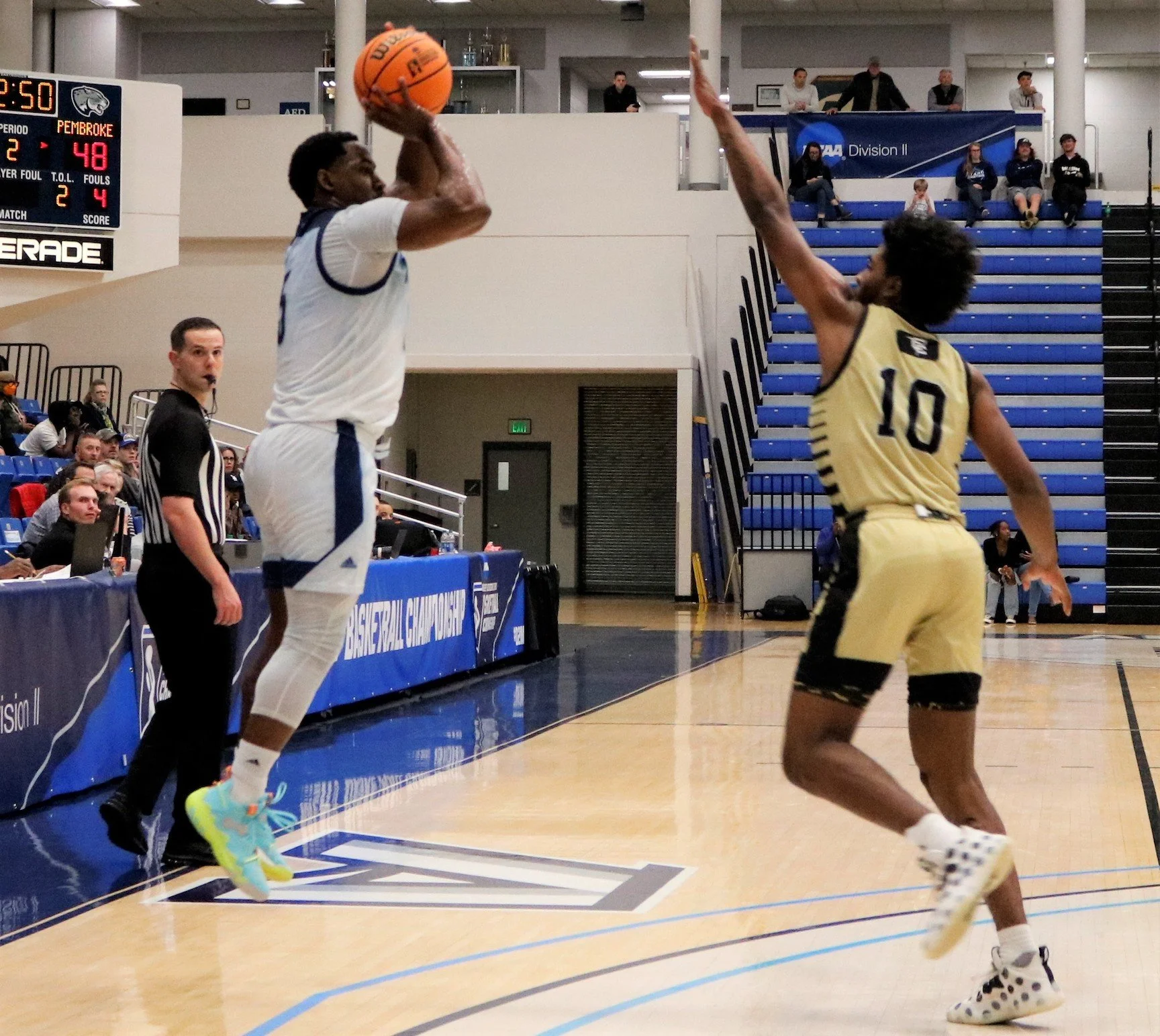  The Jaguars’ Miguel Arnold (5) launches a 3-pointer over the Braves’ Javonte Waverly (10). Arnold scored 16 points on a 4-of-6 shooting night from behind the arc. (photo by Madison Keel) 