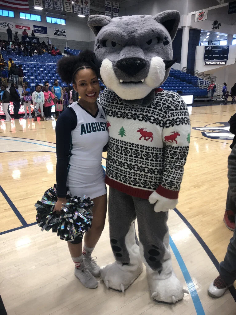   Carmelita Moreno, a junior and Grovetown High School product, and Augustus work an AU basketball game in the holiday season. (photo by AU Athletics)  