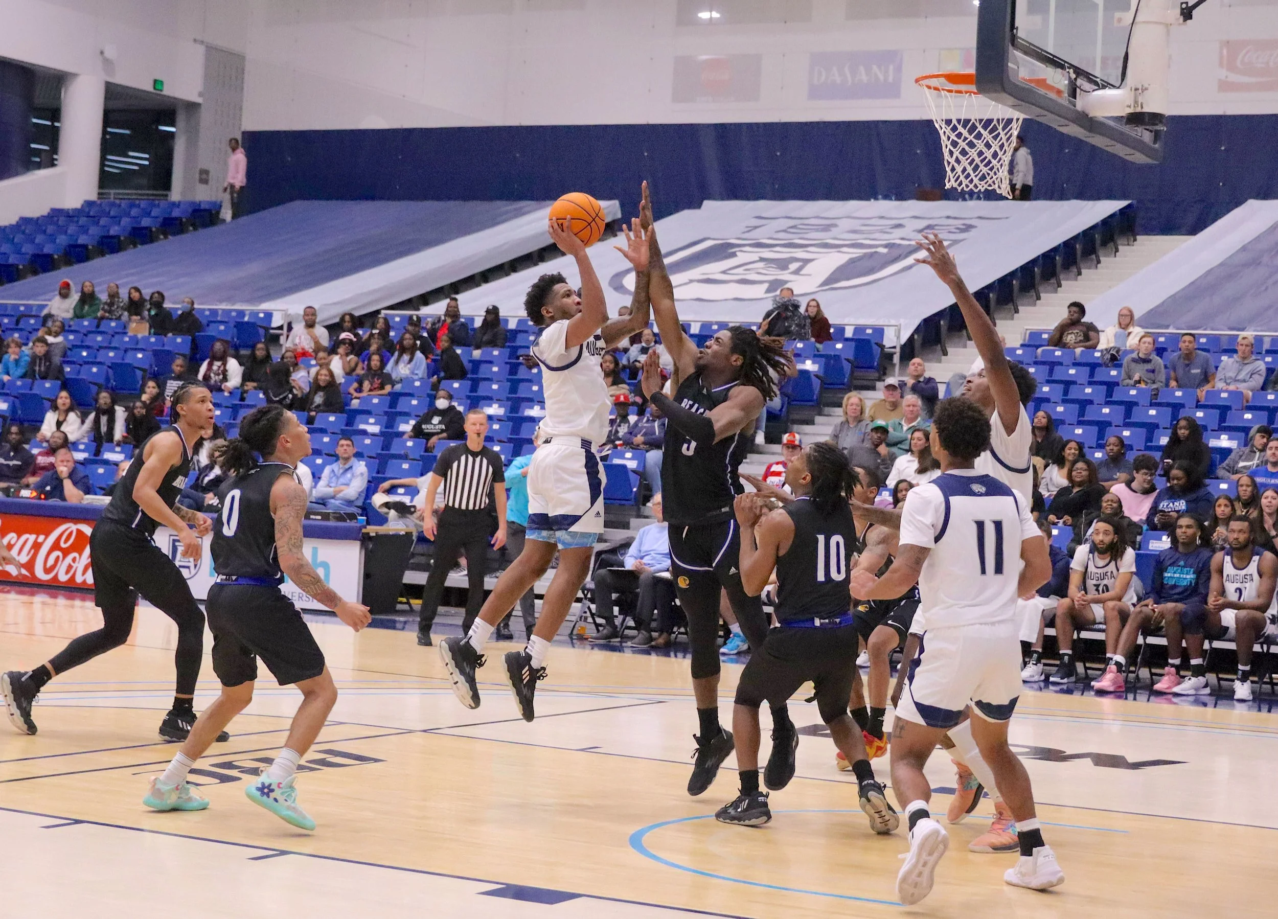  AU guard Tyree Myers goes up for two of his nine points in the narrow win over Lander. At the top of the page, teammate David Viti fires a trey. (photos by Madison Keel) 