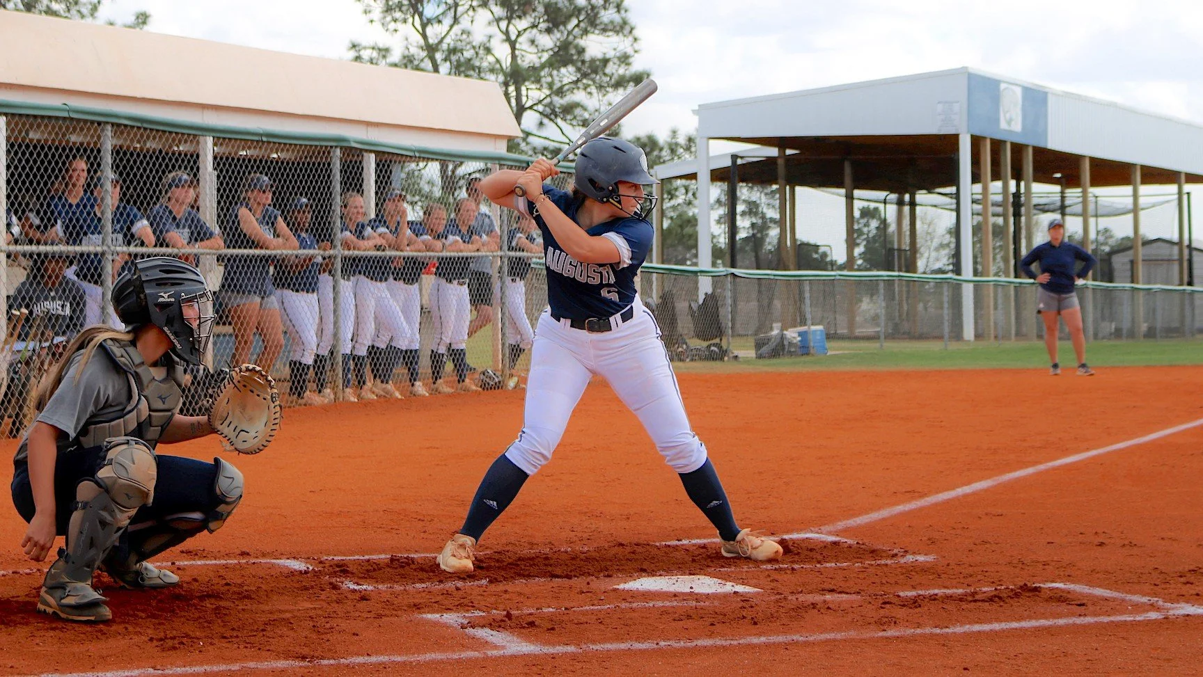  Paige Patterson (6) had an RBI single for the Jaguars in the opening game with USC Aiken. (photo by Madison Keel) At the top of the page, Maggie McBrayer shows her pitching form for Augusta. (photo by Chris Rickerson) 