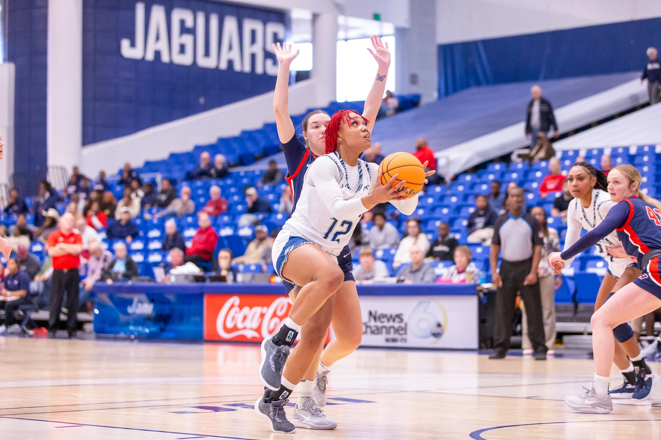  Tomiyah Alford (12) goes up for two of her 12 points in Augusta’s 75-61 victory over USC Aiken. At the top of the page, Kennedy Manning (24) was dominant with a 17-point, nine-rebounding outing. (photos by Paula Toole, AU Athletics) 