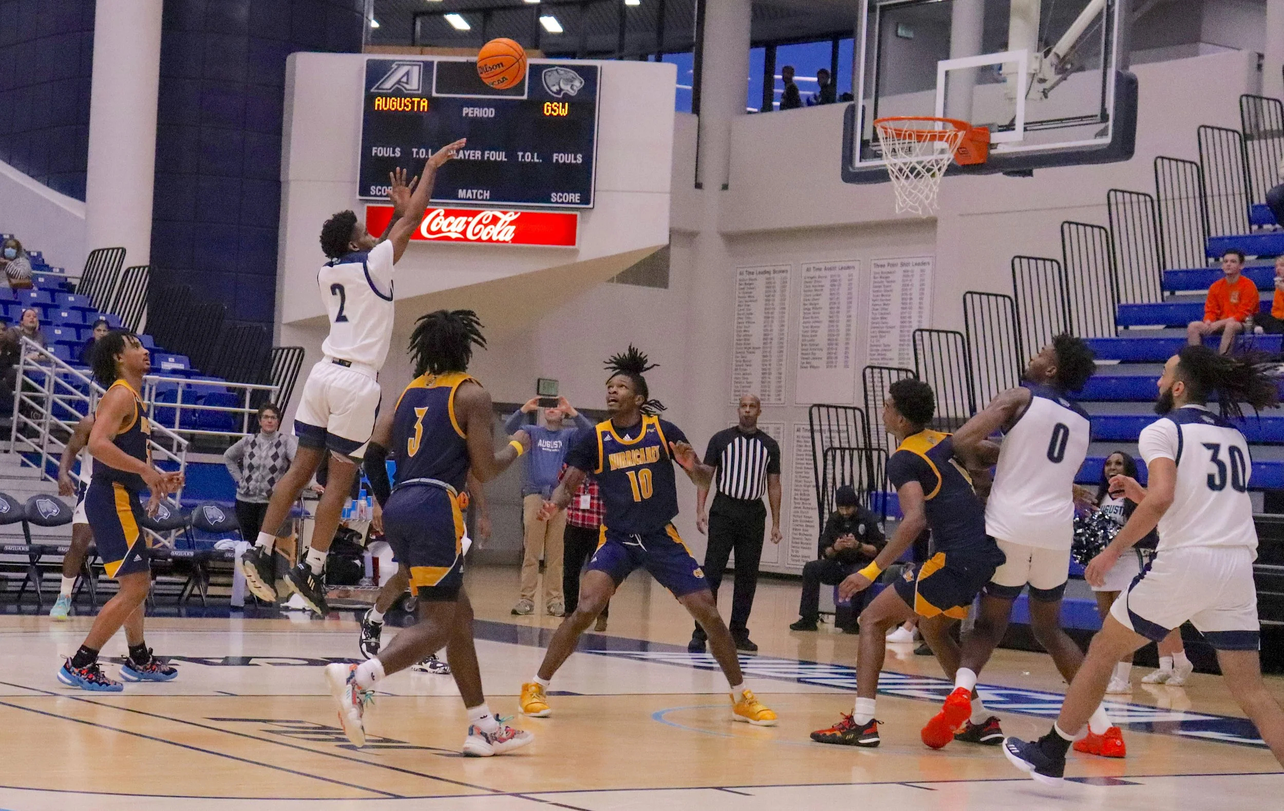  Guard Tyree Myers (2) goes up for a short jumper for Augusta University in its 74-65 win over Georgia Southwestern. At the top of the page, Darren Lucas-White (11) drives in for a layup against the Hurricane defense. (photos by Madison Keel) 