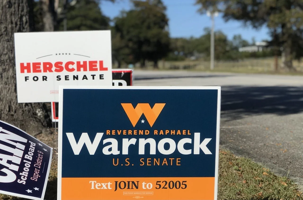  Incumbent Sen. Raphael Warnock and Herschel Walker will run against each once again in a runoff election.  (photo by Rakiyah Lenon)  