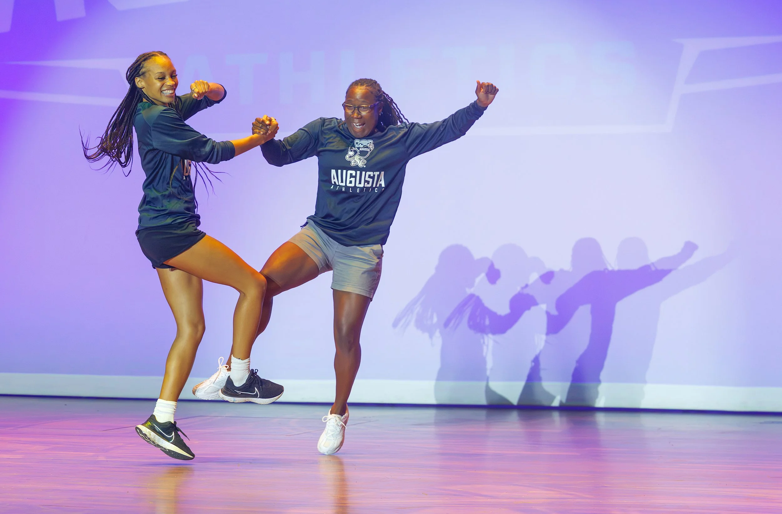  Assistant women’s basketball coach Mone Florence and coach Celeste Stewart do a little dancing during the athletics welcome-back event at the Maxwell Performing Arts Theatre. At the top of the page, men’s coach Dip Metress fires a T-shirt into the crowd. (photos by Paula Toole/AU Athletics) 